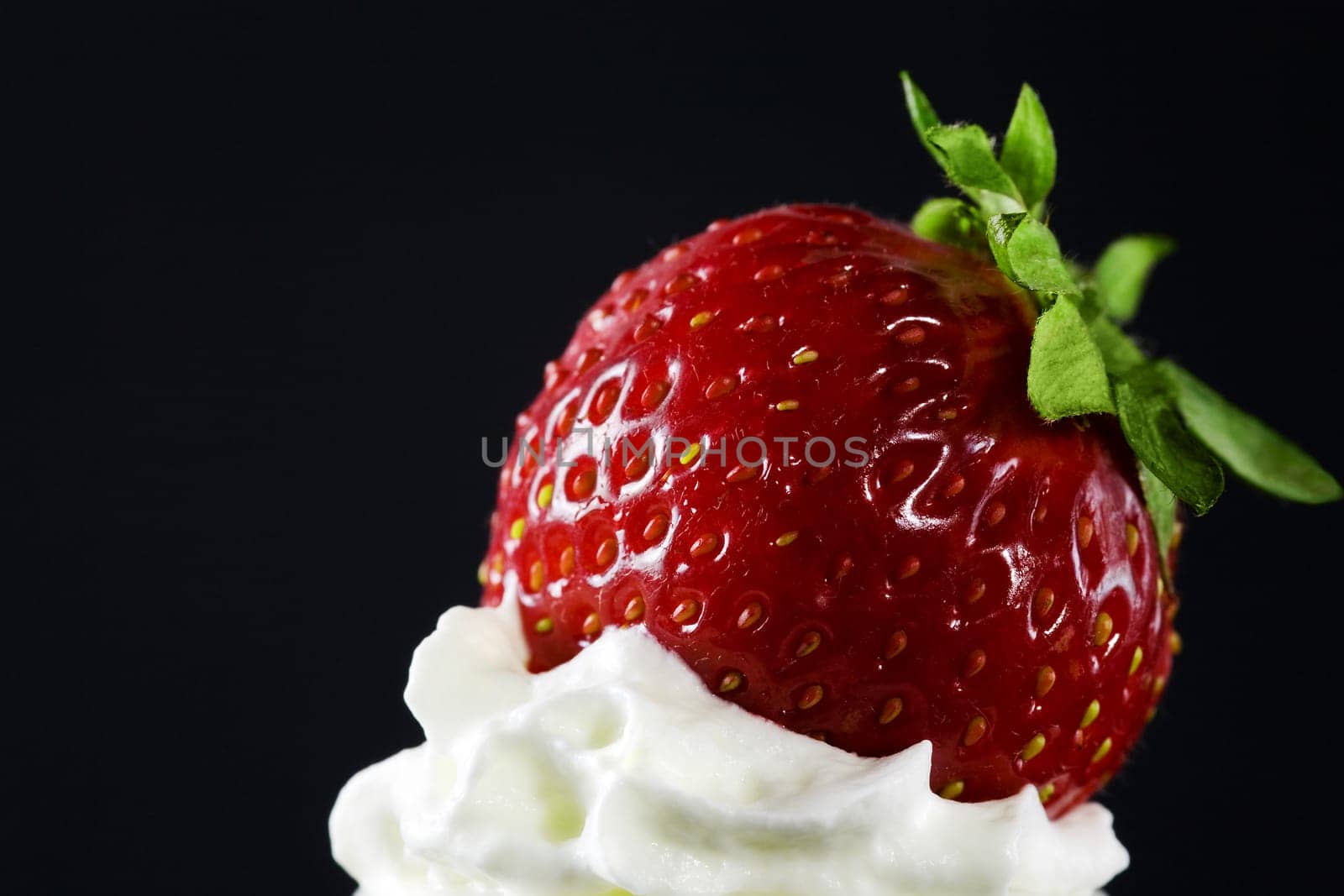 A strawberry on top of the icing