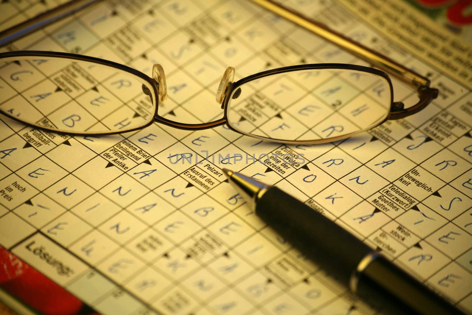 Crossword puzzle with glasses and pen