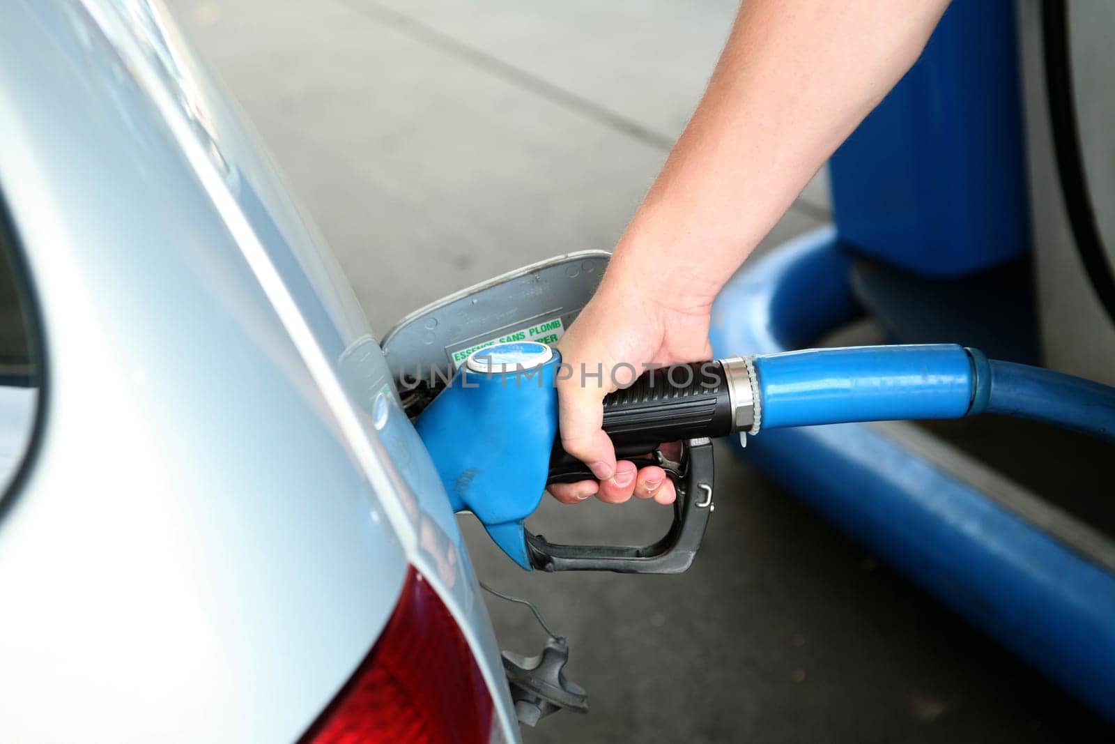Hand with fuel nozzle