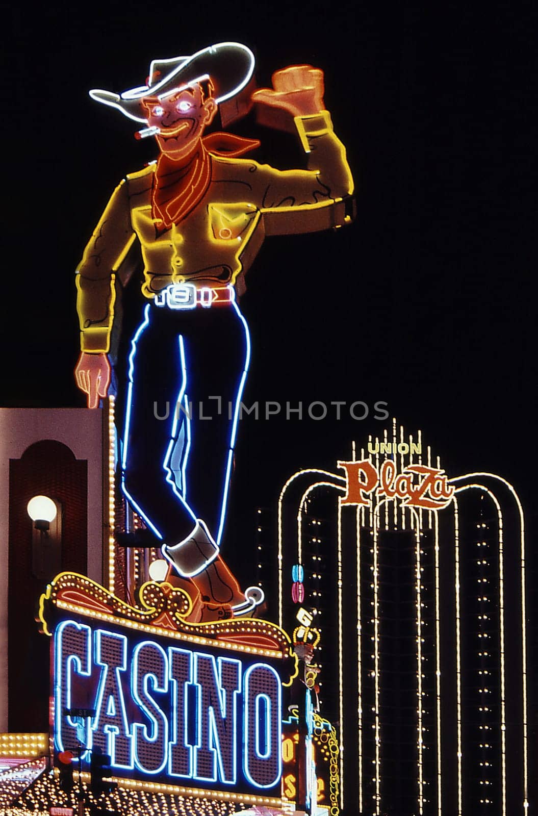The well-known symbol of the city has stood on Fremont Street for over 50 years and waves to people. Scan of the slide