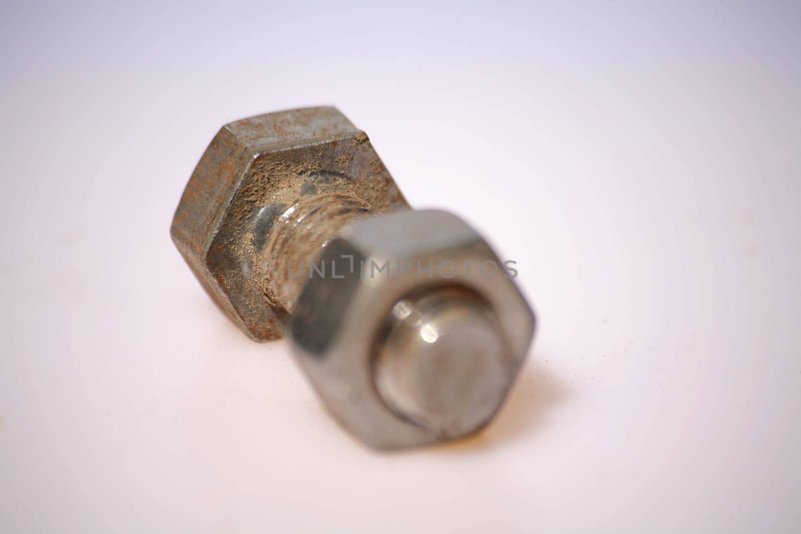 Short screw with nut against white background