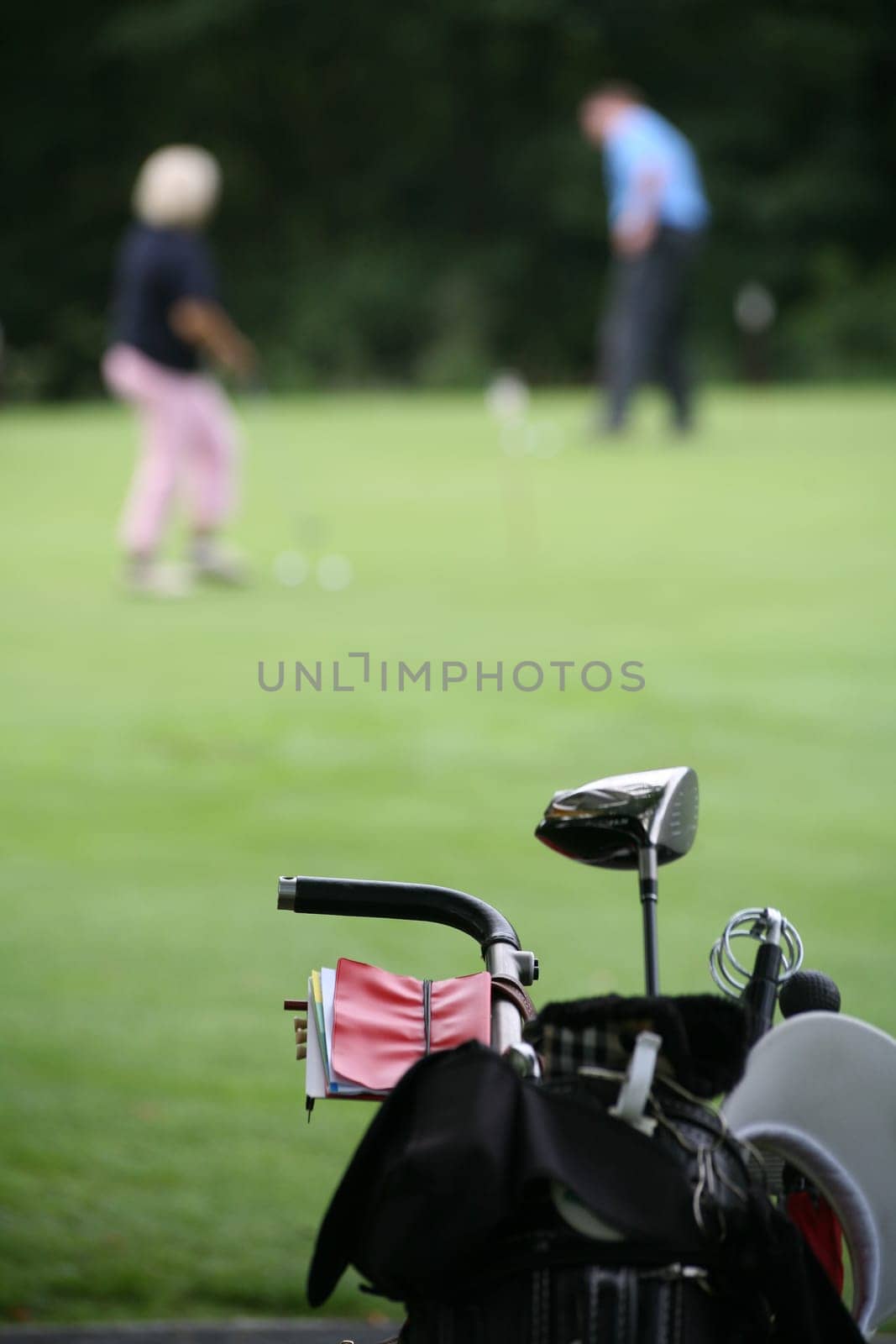Golf trolley and golfers at a golf tournament