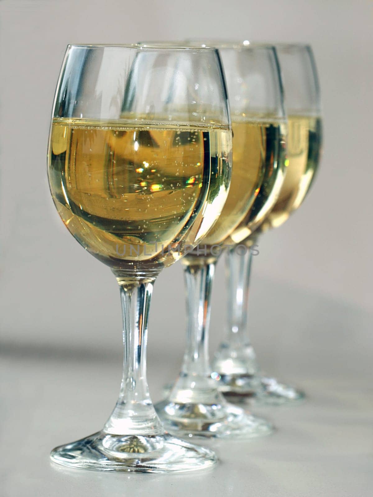 Three wine glasses offset in a row.