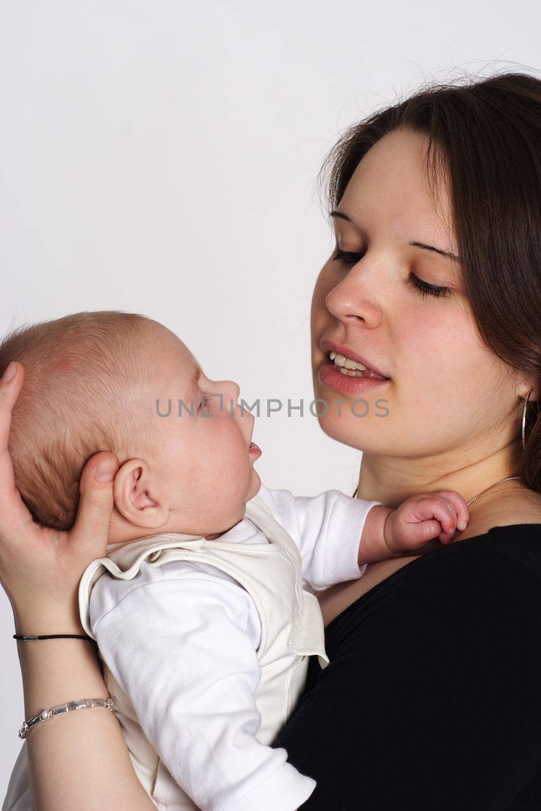 Mom holds her child in her arms and they look into each other's eyes