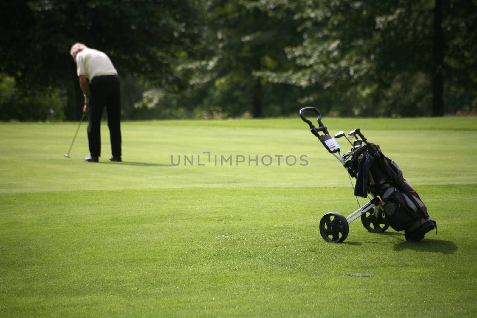 Golf trolley and golfers at a golf tournament
