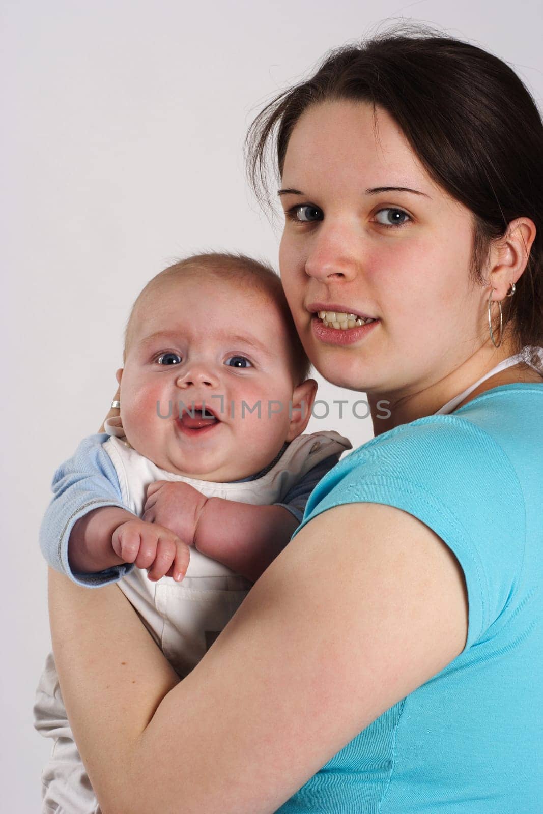 Mother holding laughing baby in her arms