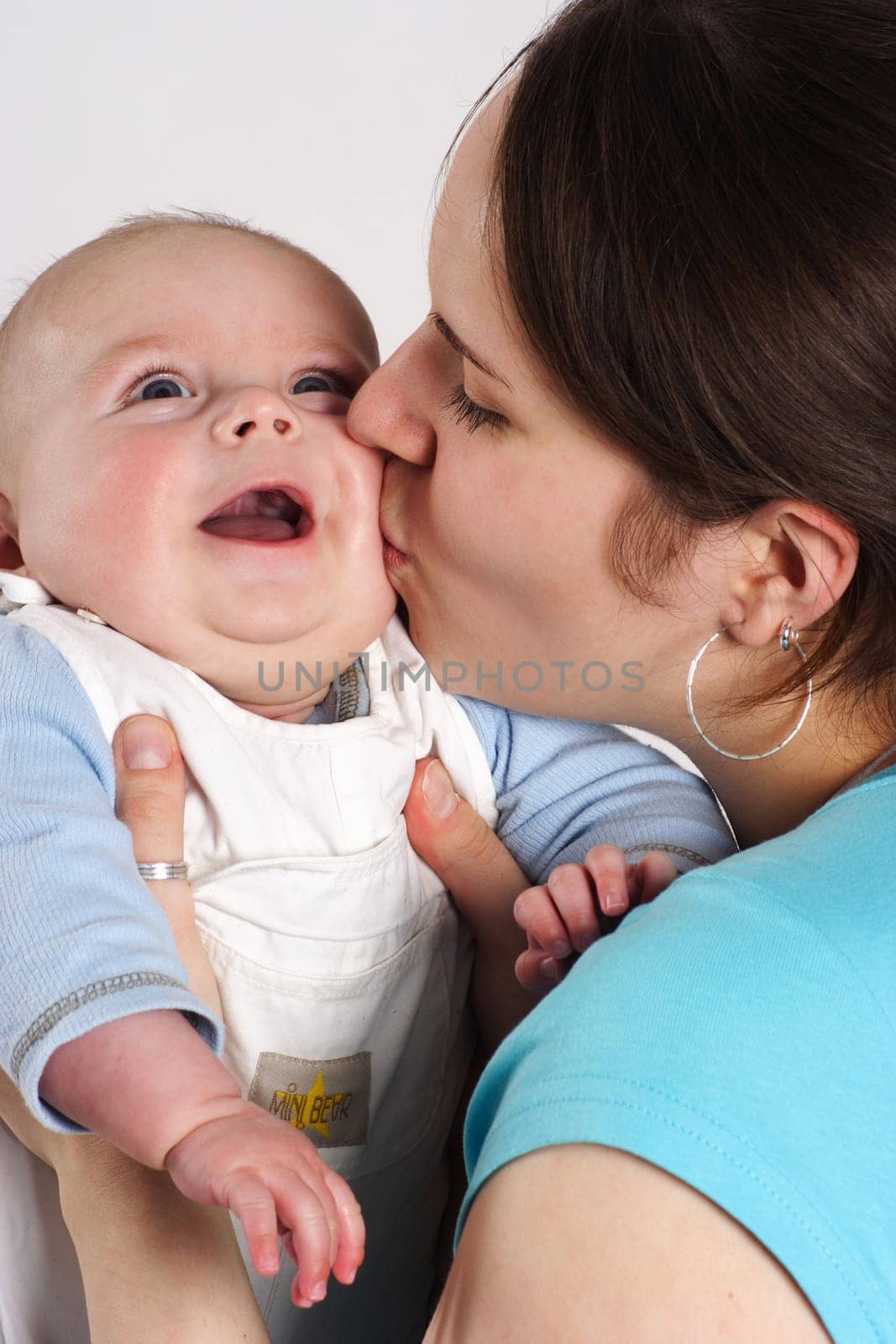 Mom kisses the child in her arms