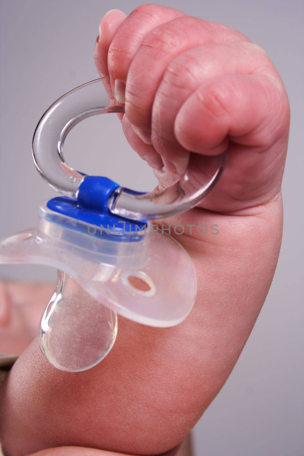 Baby hand holds a teat