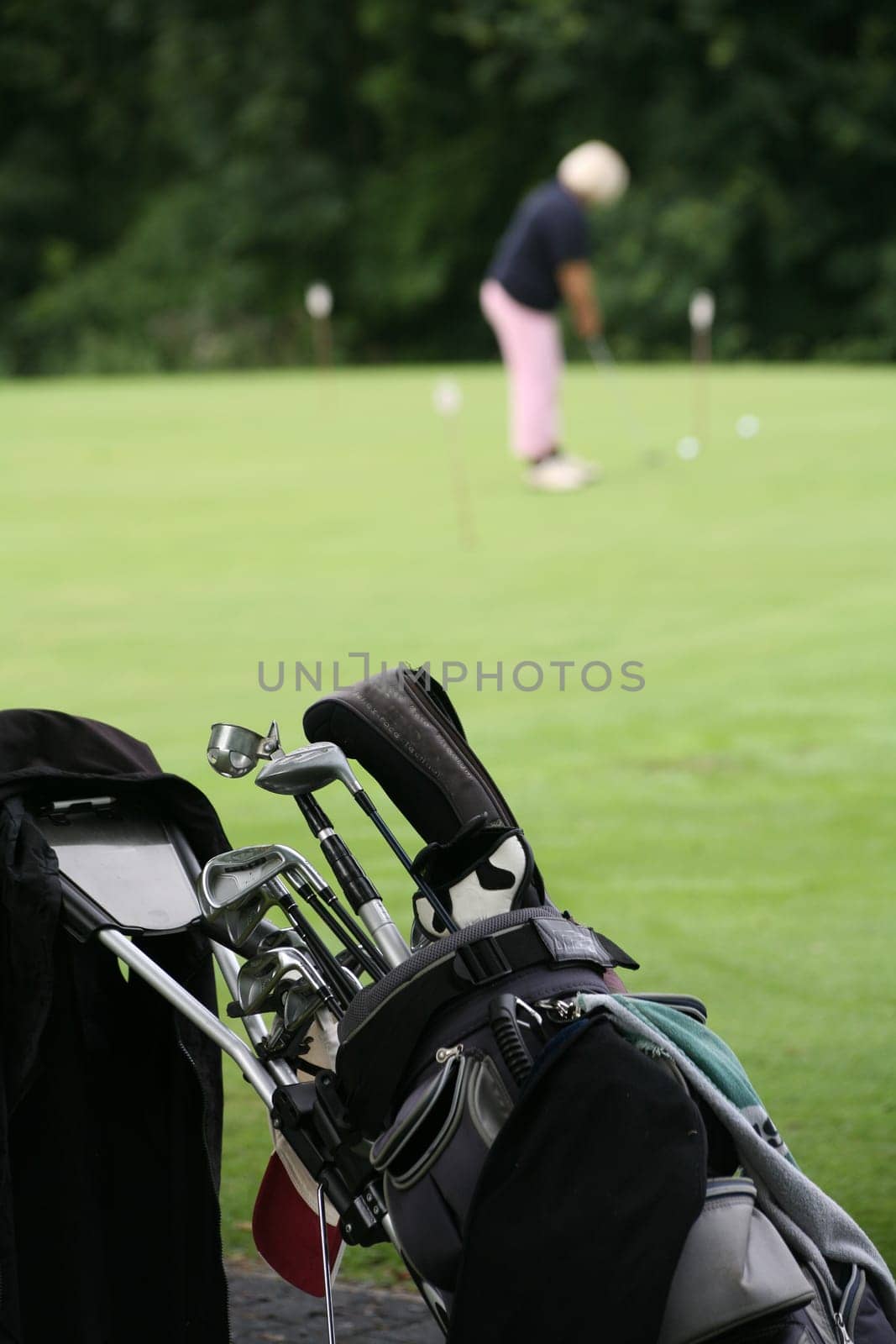 Golf trolley and golfers at a golf tournament