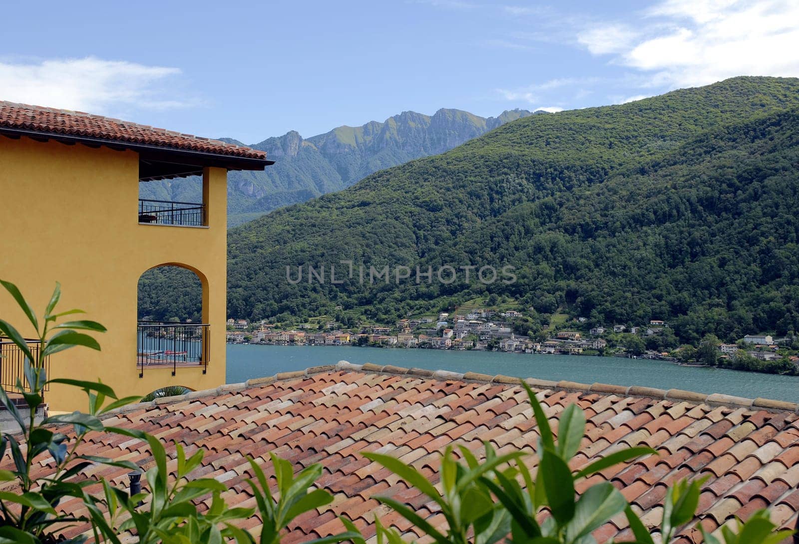 Wonderful view over the rooftops of Morcote to the village of Brusino-Arsizio. In the background you can see the Monte Generoso massif,which also forms the border mountains with Italy.