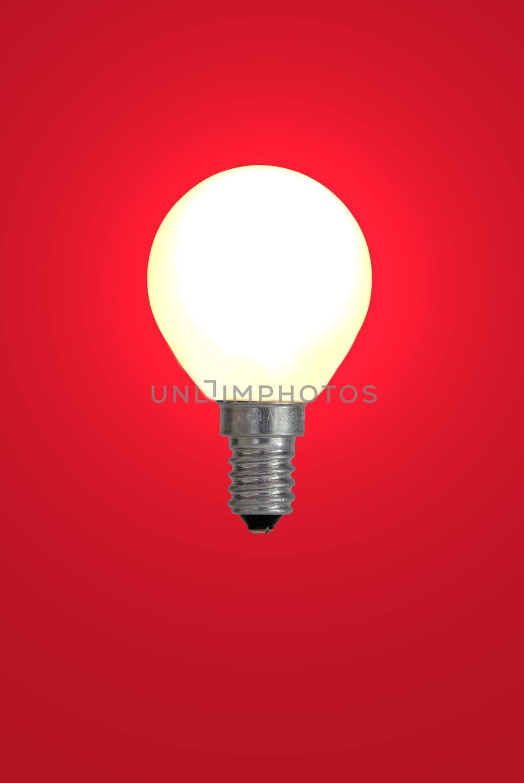 Light bulb against red background