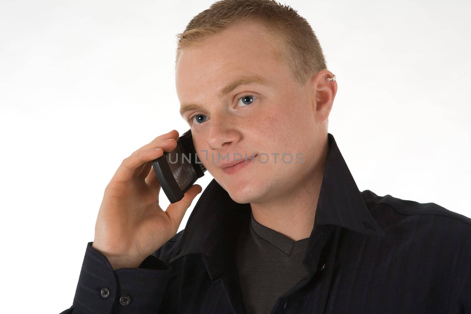 A young man talking on a mobile phone