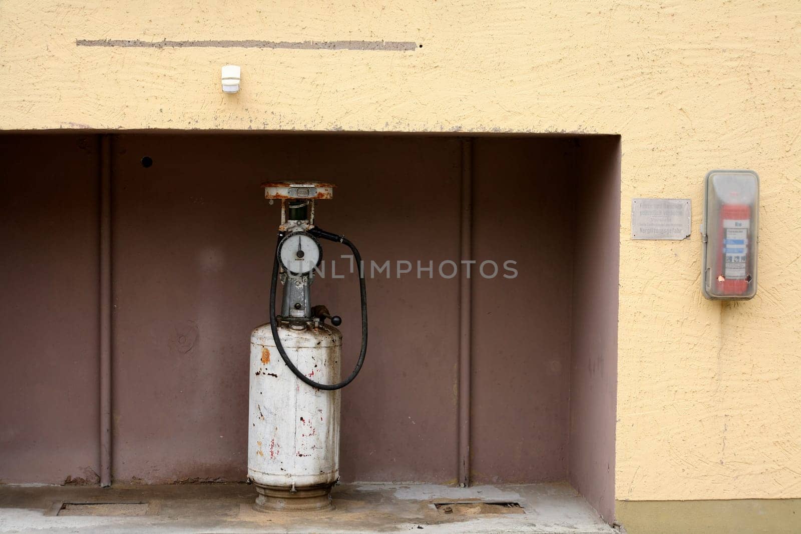 Rusty fuel pump with fire extinguisher
