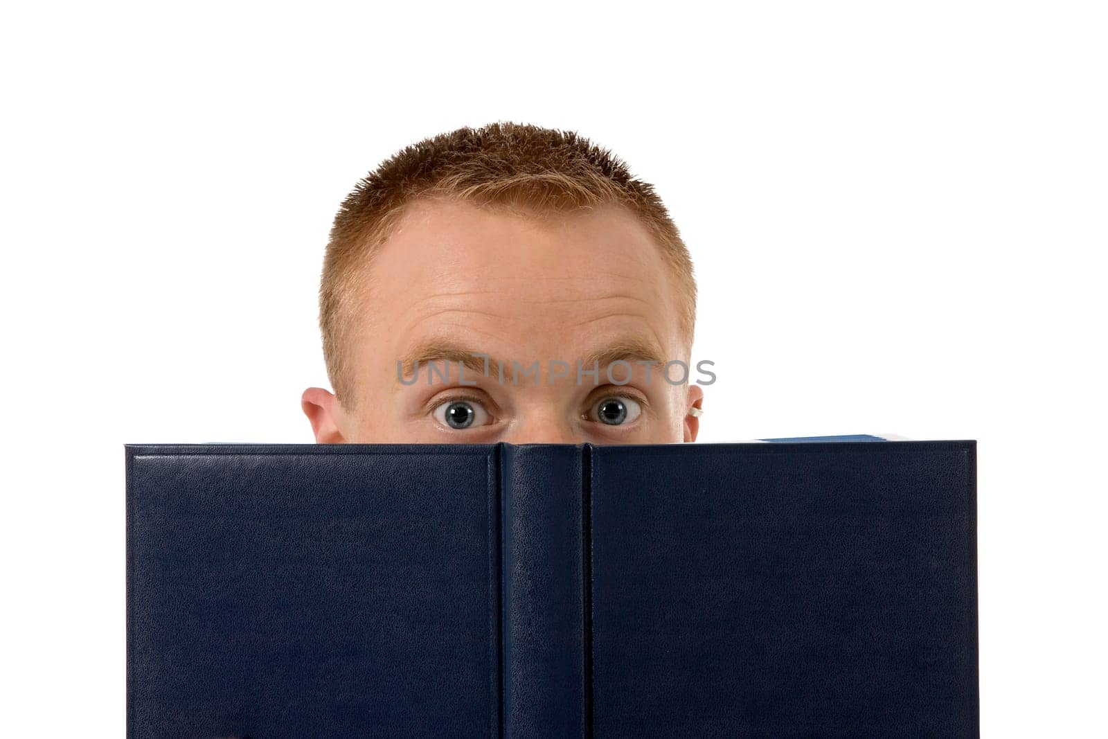 A young man with a book slightly hidden behind it