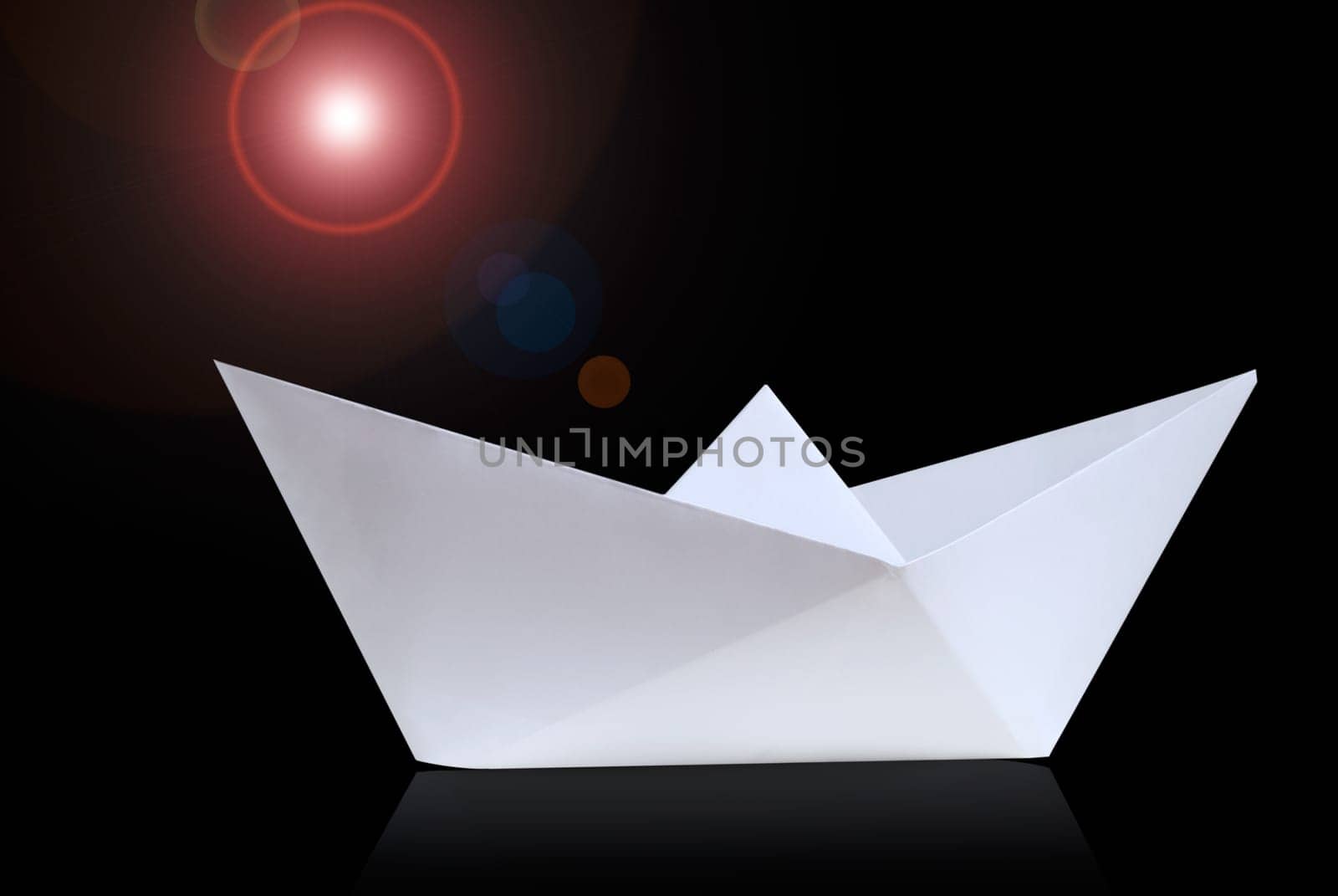 Paper ship against a black background