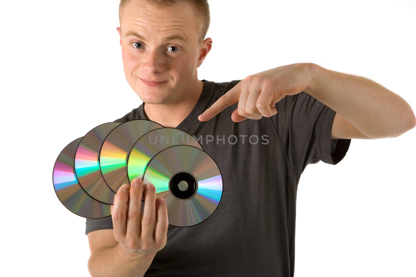 A young man with CDs in his hand,with the other he points to the CDs