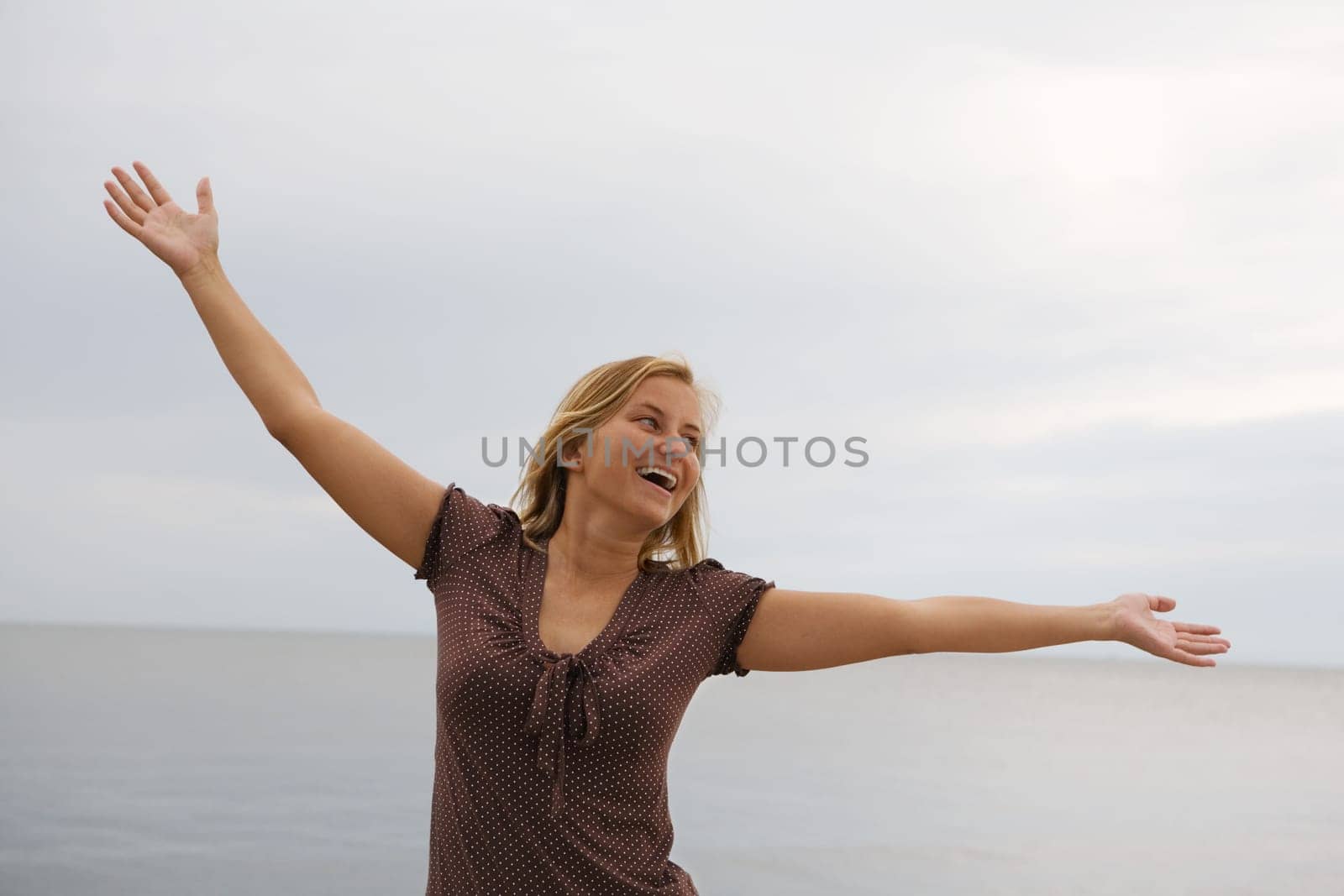 A young carefree happy woman in a jubilant pose