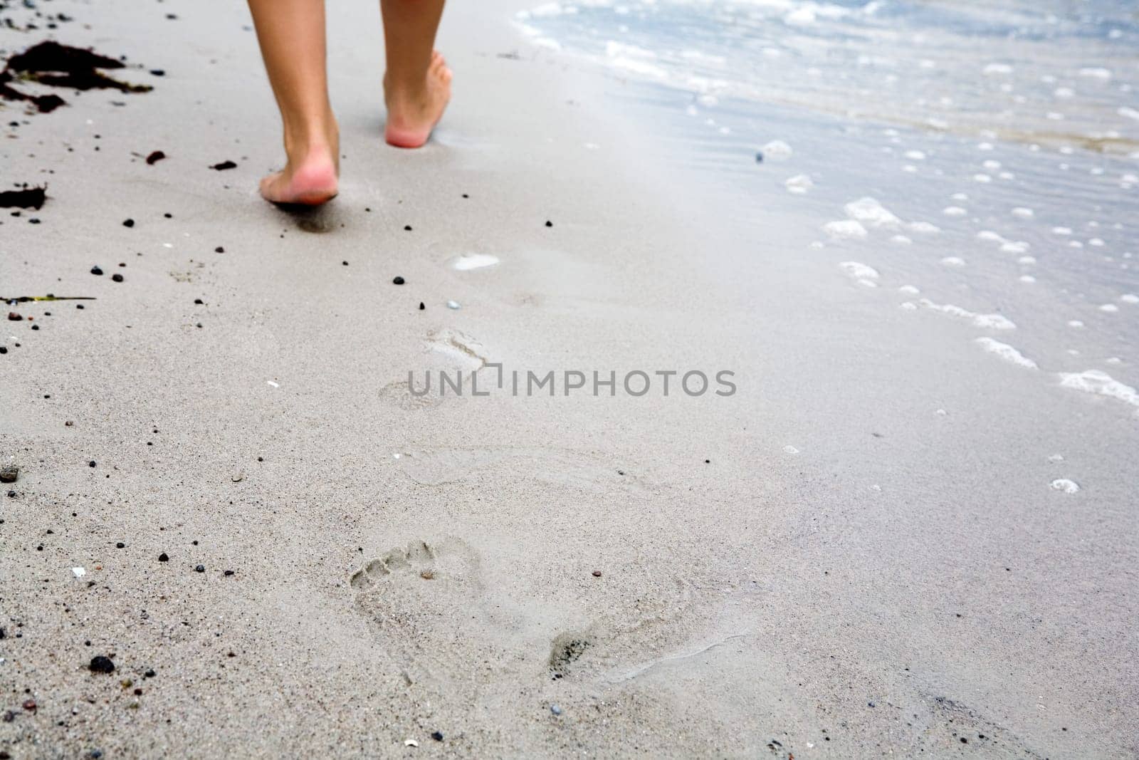 Footprints in the sand In the background you can see the feet
