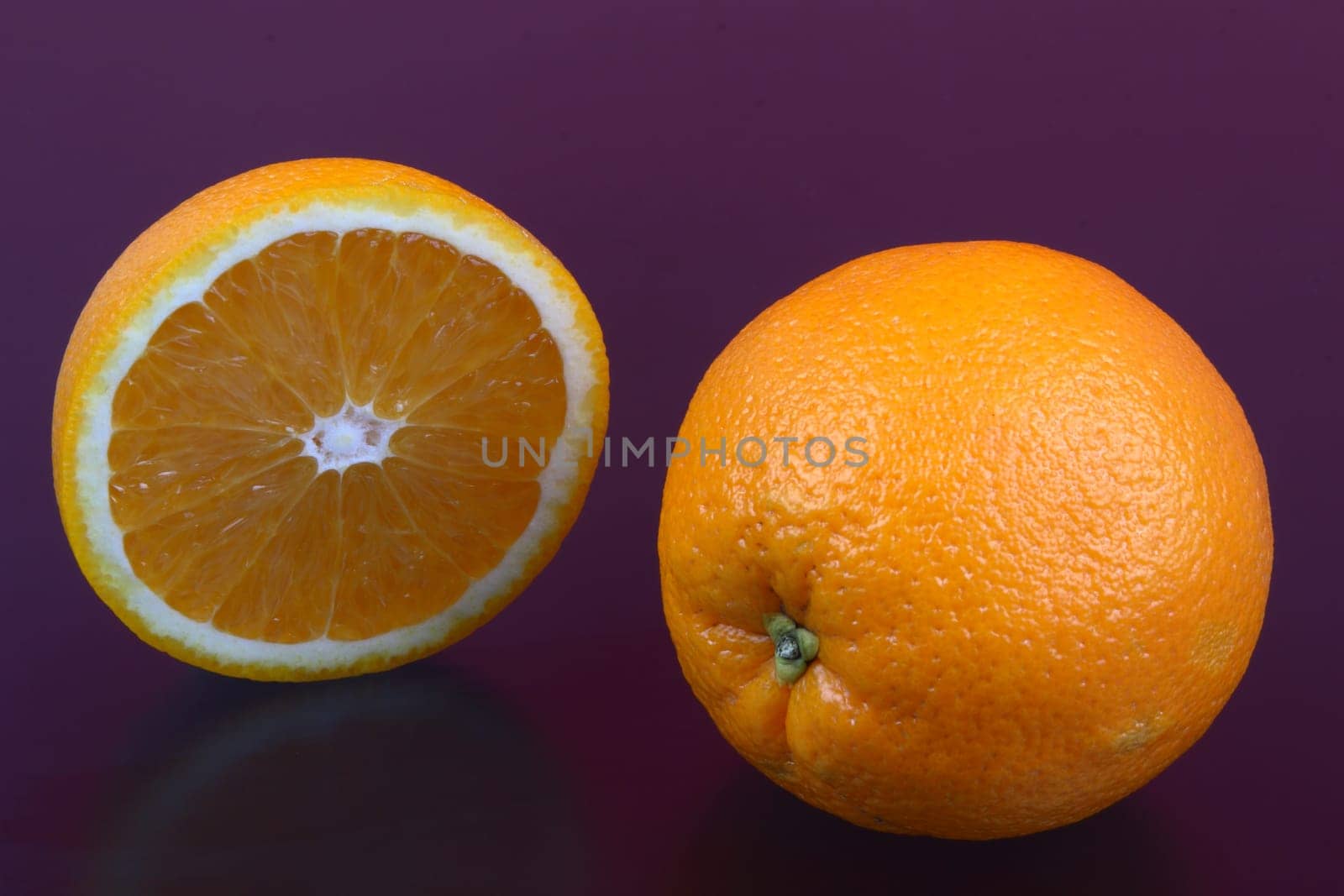 Orange and orange slices on different surfaces