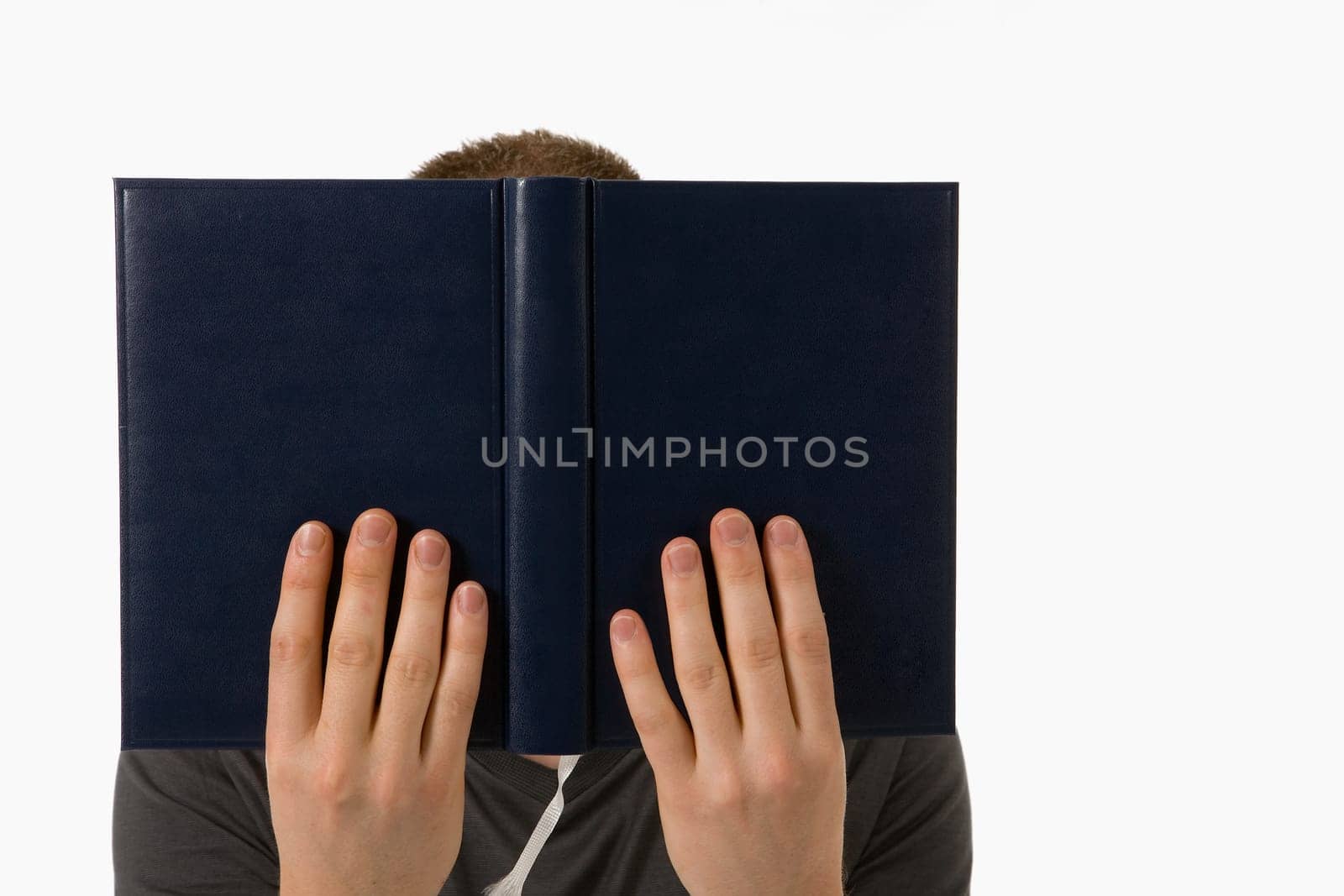 A young man is engrossed in his book