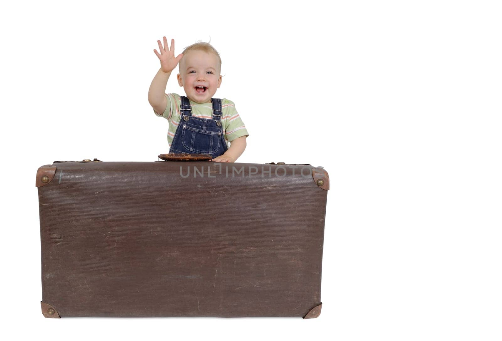 Toddler with suitcase. Studio recording