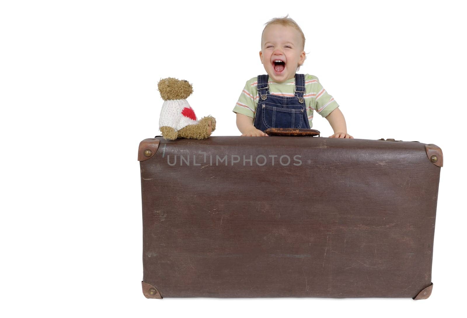 Toddler with suitcase and teddy bear. Studio recording
