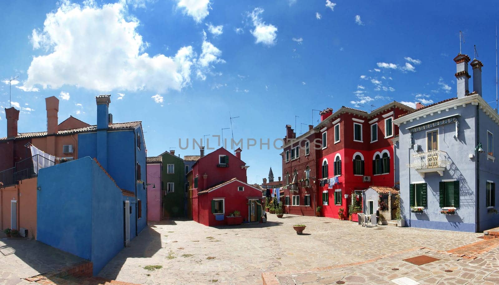 The island of Burano is located near Venice,and is known for its beautifully painted houses. The image is composed of six portrait images.