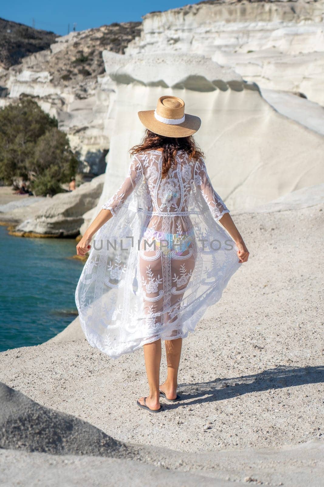 Model playing with her dress on Sarakiniko beach, Milos Island