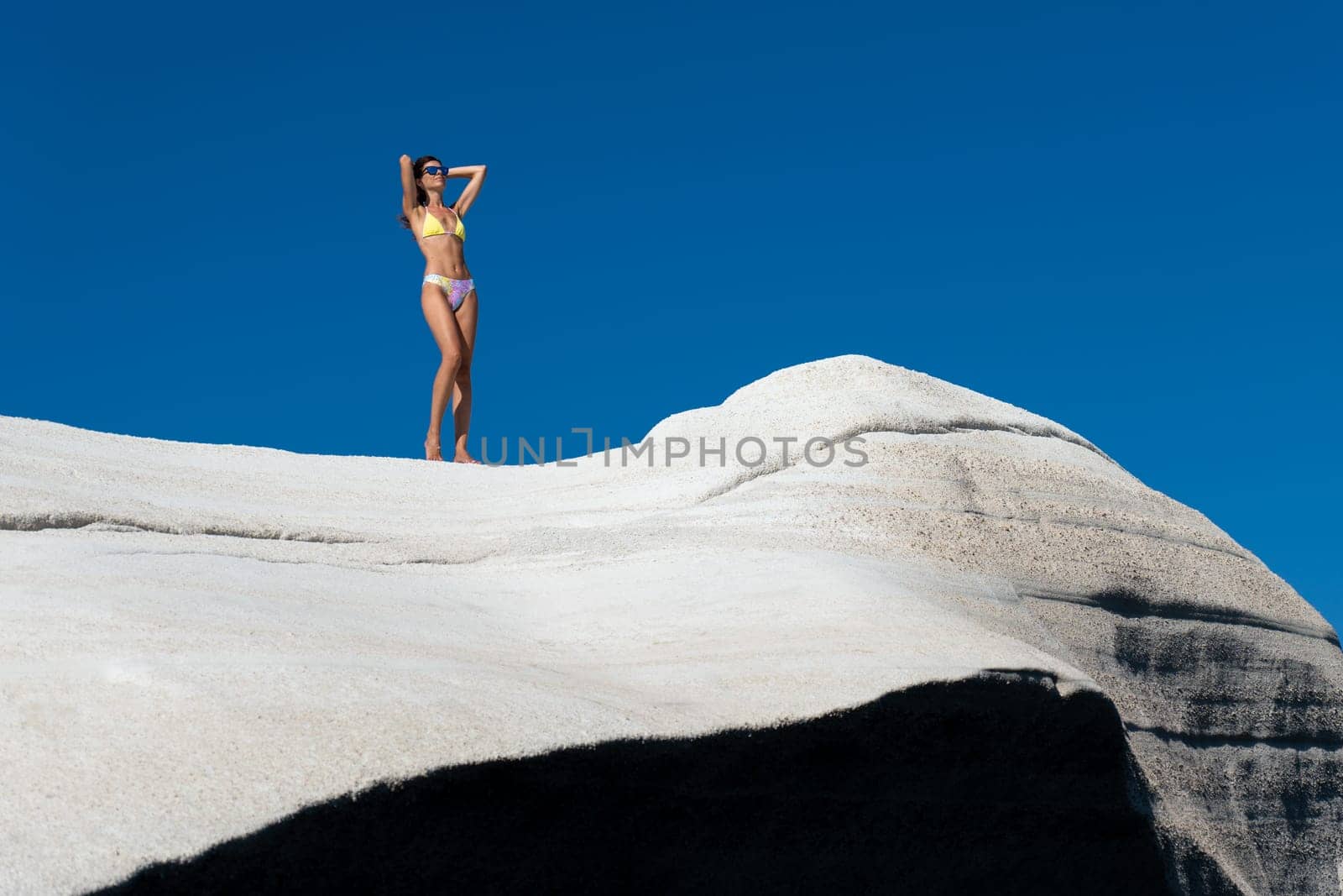 Model in bikini on Sarakiniko beach, Milos Island by LopezPastor