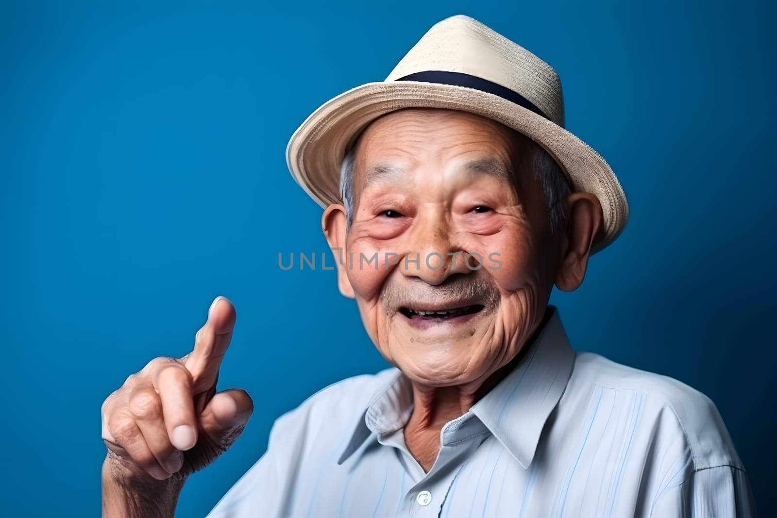 Asian grandfather looking and smiling with rised index finger on blue background. Neural network generated in May 2023. Not based on any actual person, scene or pattern.