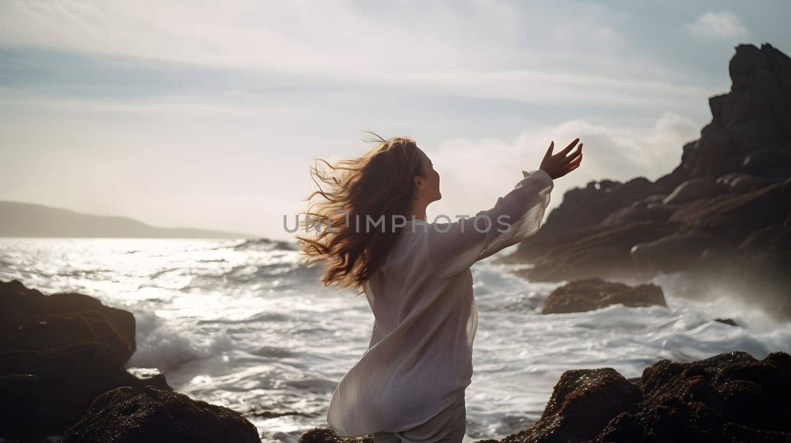 woman standing with rised hands in front of rocky sea shore with waves and splashes. Neural network generated in May 2023. Not based on any actual person, scene or pattern.