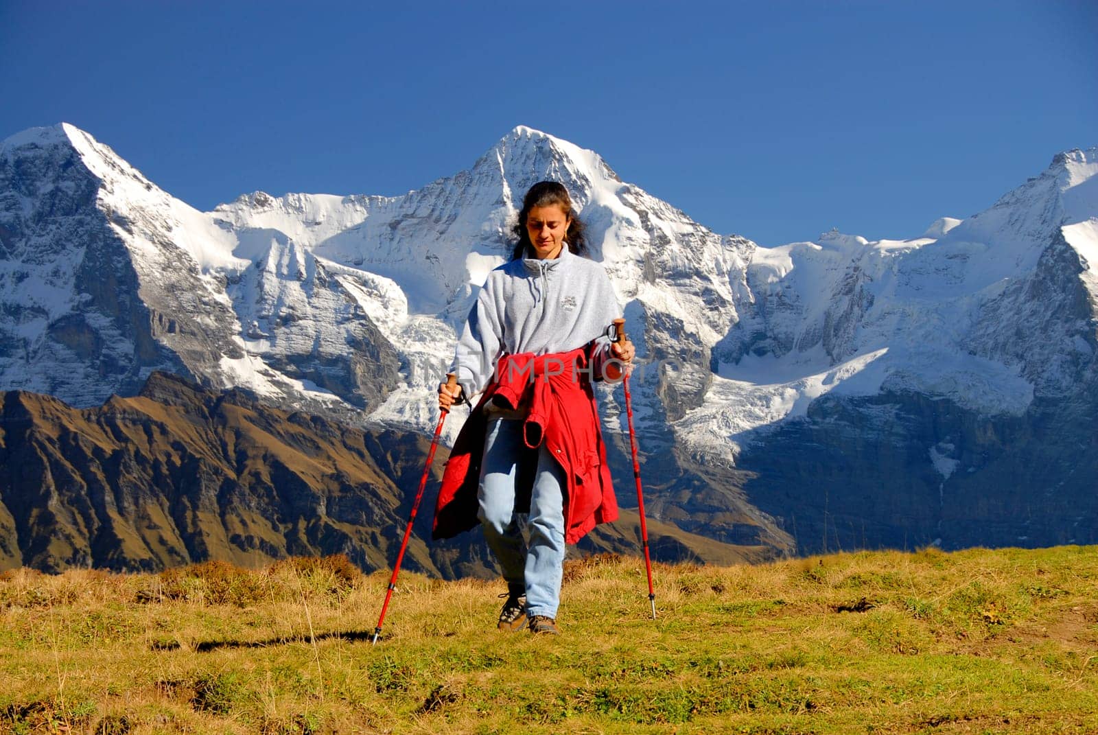 Hiking with fantastic scenery. In the background from left to right,the Eiger (Eiger North Face) 3970m,the Mönch 4107m and the Jungfrau 4158m high. The Jungfraujoch,located between the Mönch and the Jungfrau,has the highest railway station in Europe at 345