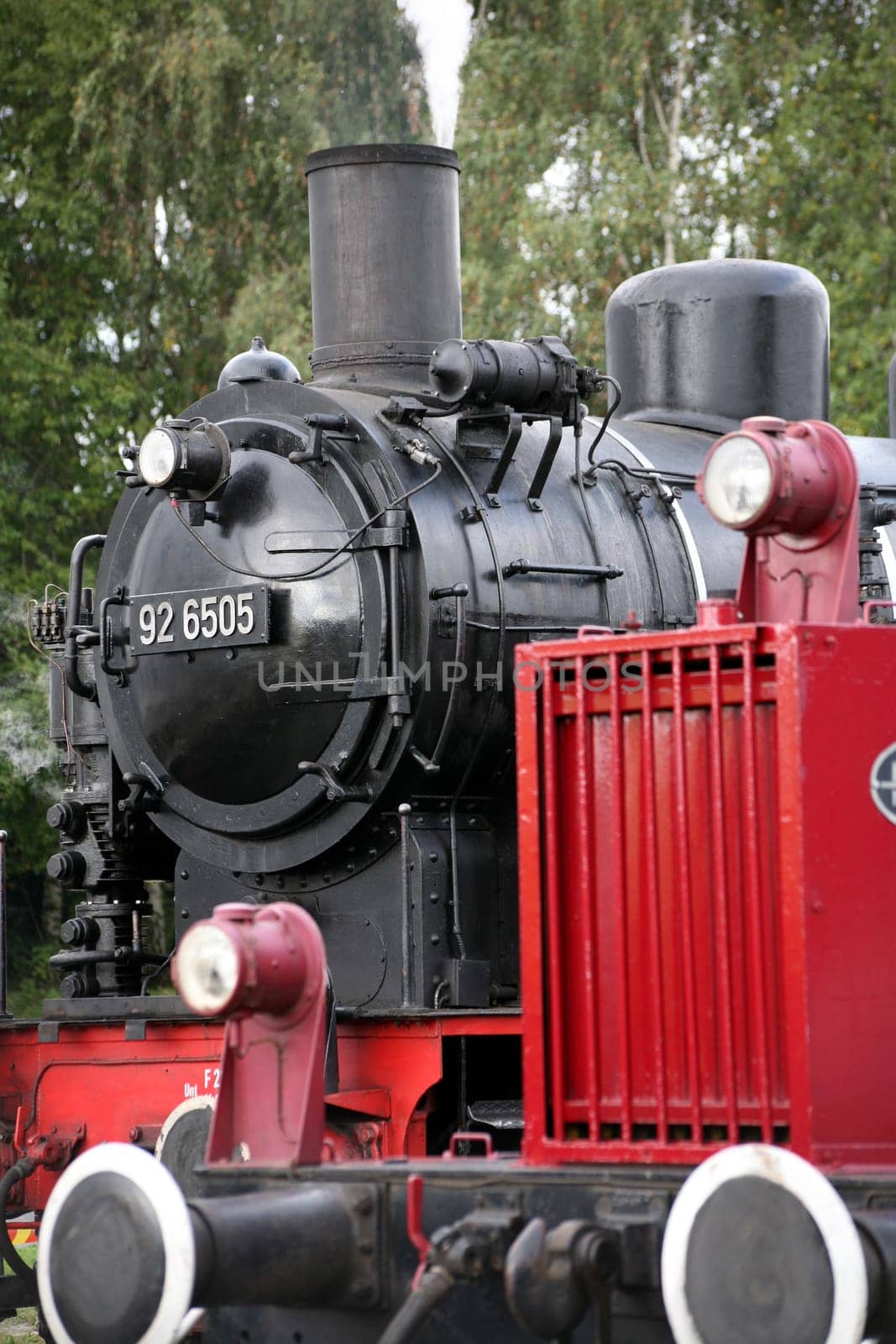 Steam locomotive and diesel locomotive (red,in the foreground)