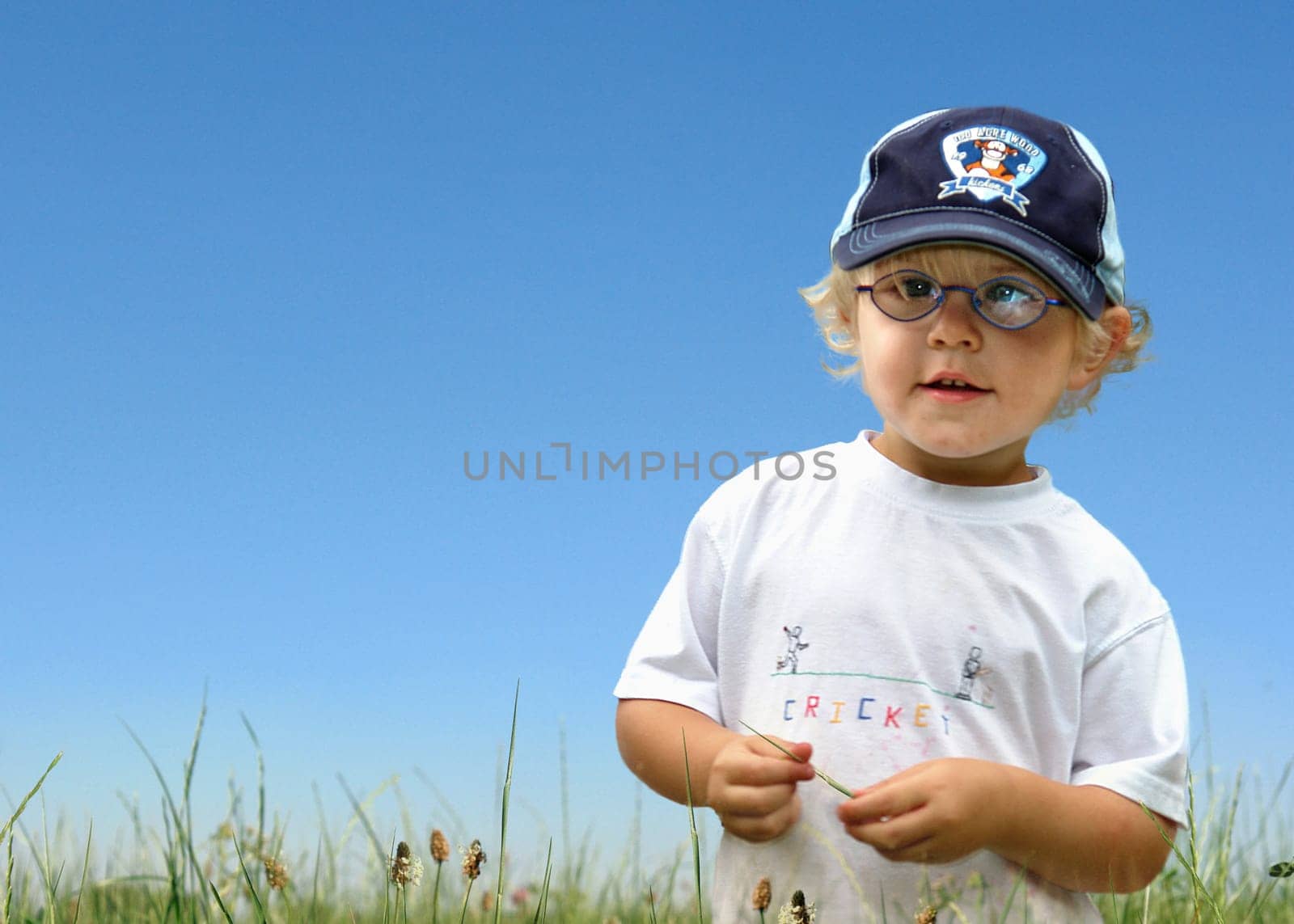 Boy running over meadow motion blur