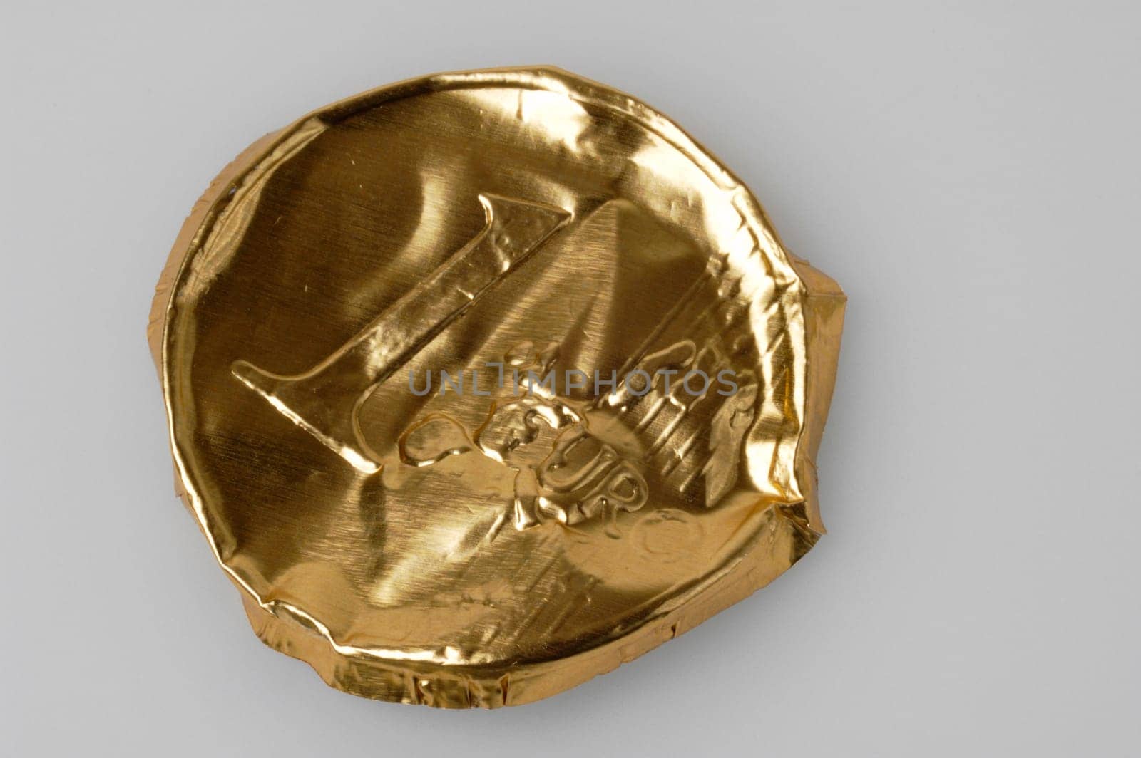Crumpled packaging of a chocolate euro