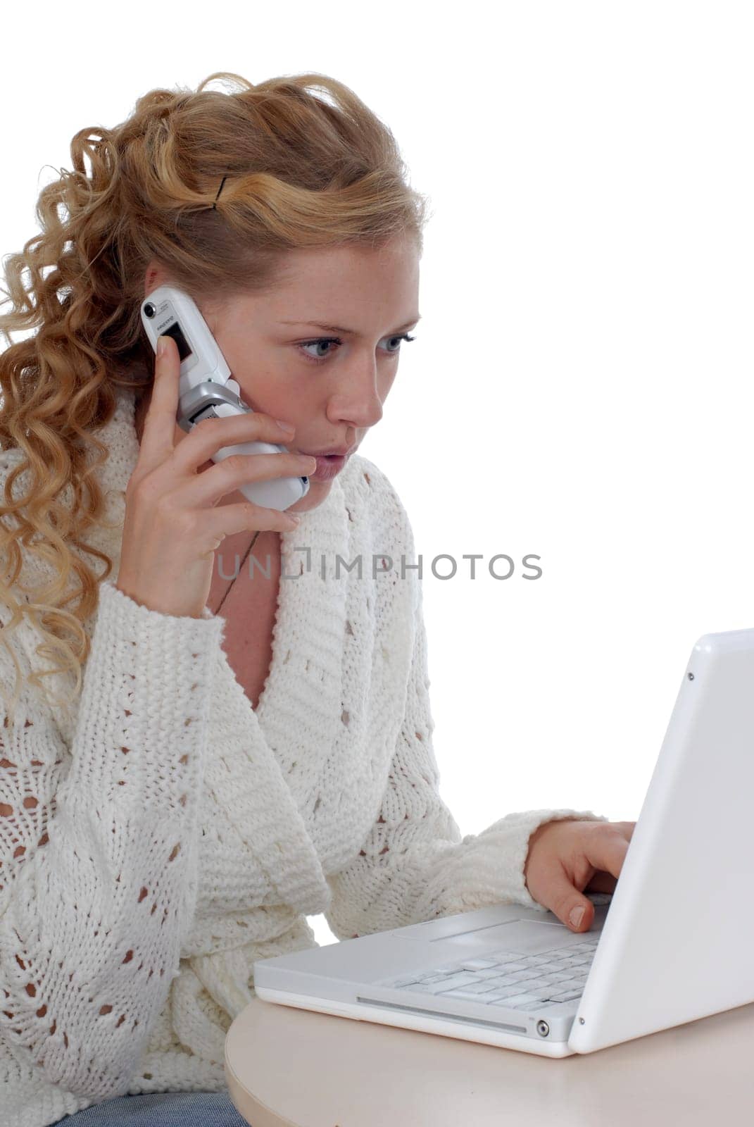 Young woman with laptop and mobile phone