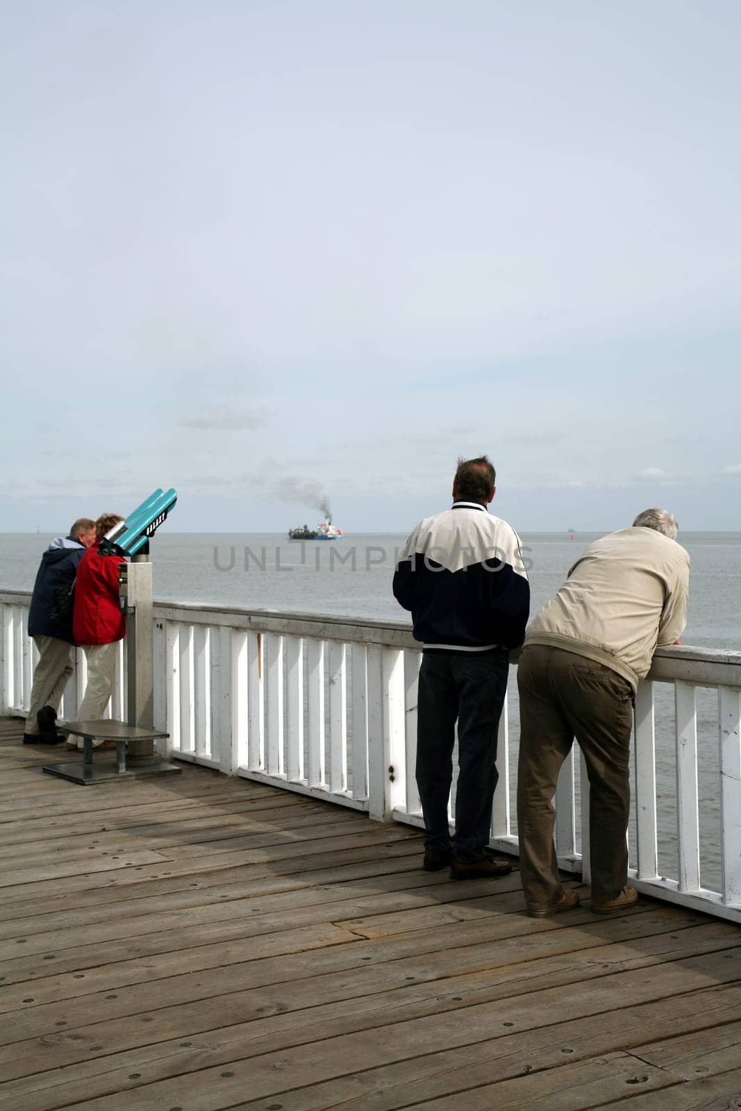 Tourists on the viewing platform at the Alte Liebe in Cuxhaven (North Sea). Here the big pots come very close to the coast on the way from/into the Elbe.