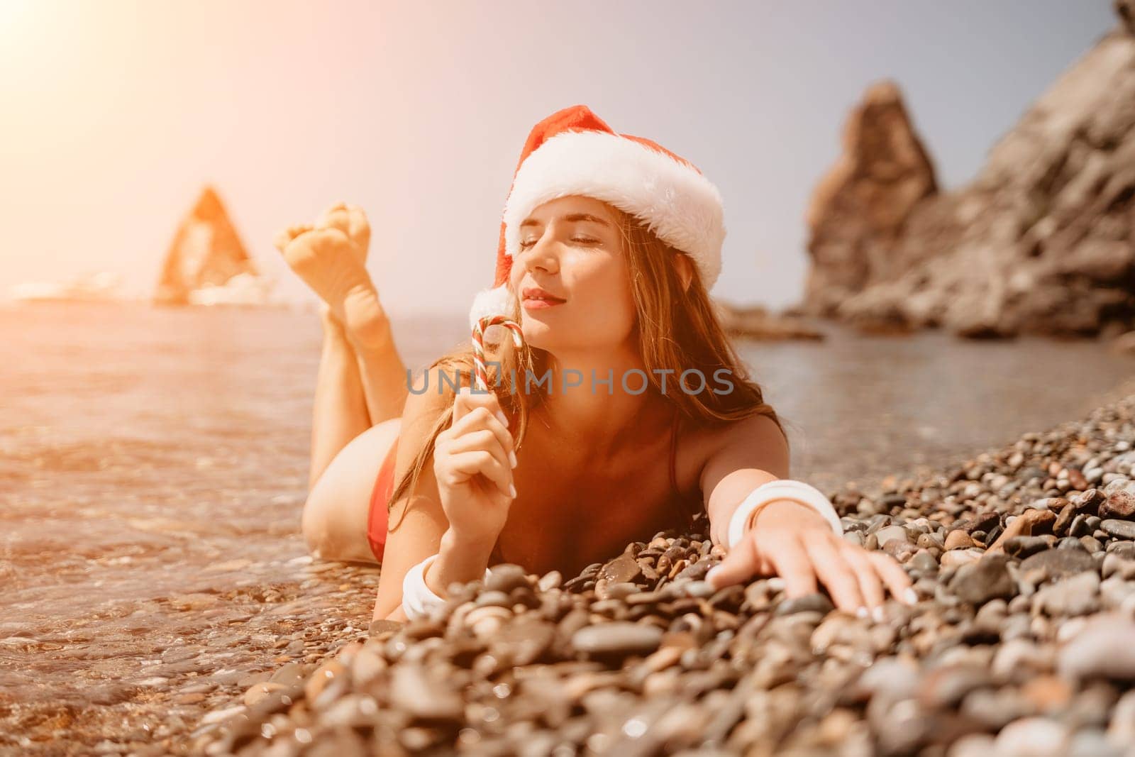 Woman travel sea. Happy tourist taking picture outdoors for memories. Woman traveler looks at the edge of the cliff on the sea bay of mountains, sharing travel adventure journey.