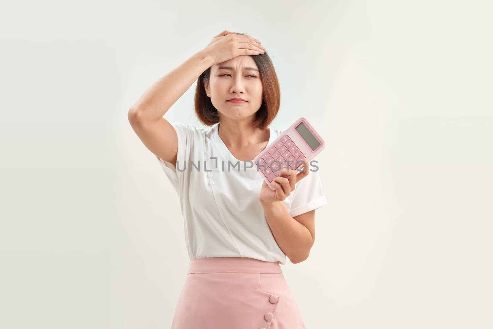 young attractive asian woman having an electronic calculator