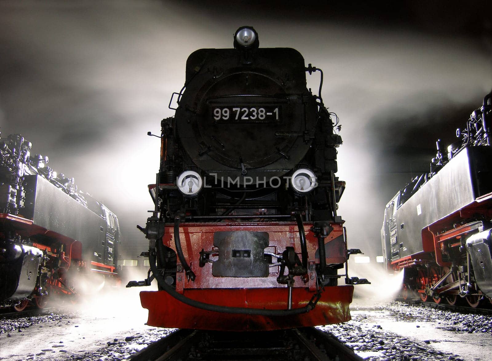 I took this picture in Wernigerode,in front of a locomotive shed. The locomotives are maintained there and are ready for the next day. The steam and backlight create beautiful effects.
