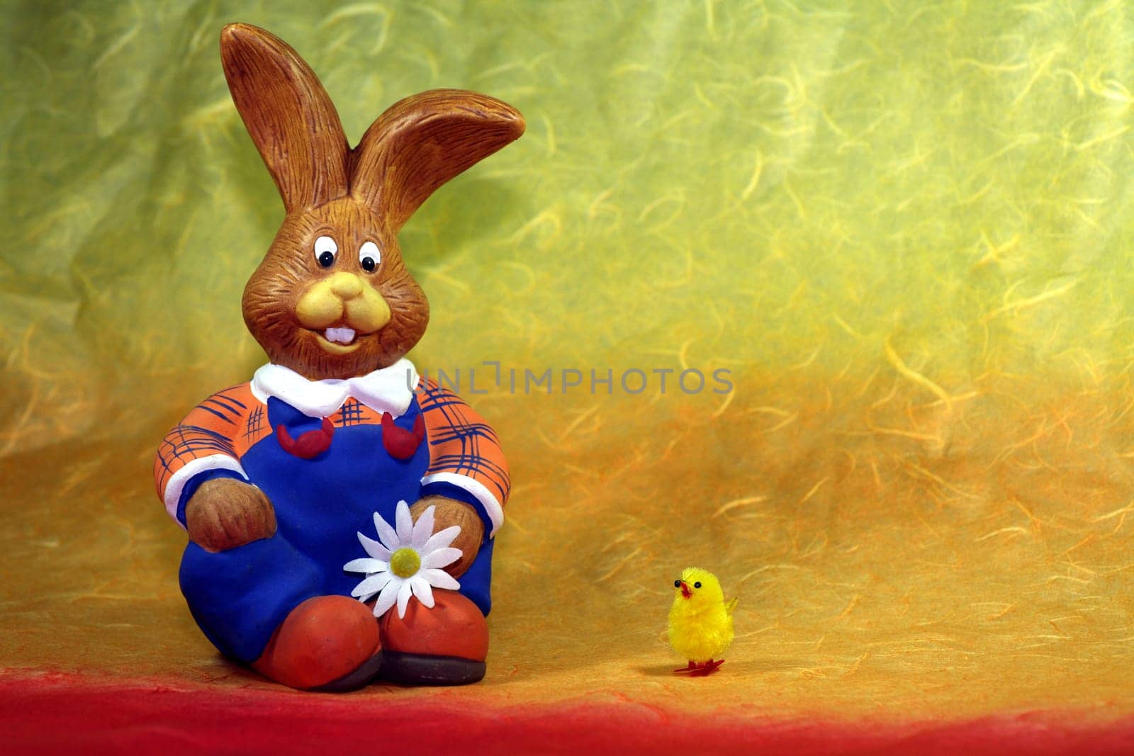 Rabbit figure in blue dungarees with pet