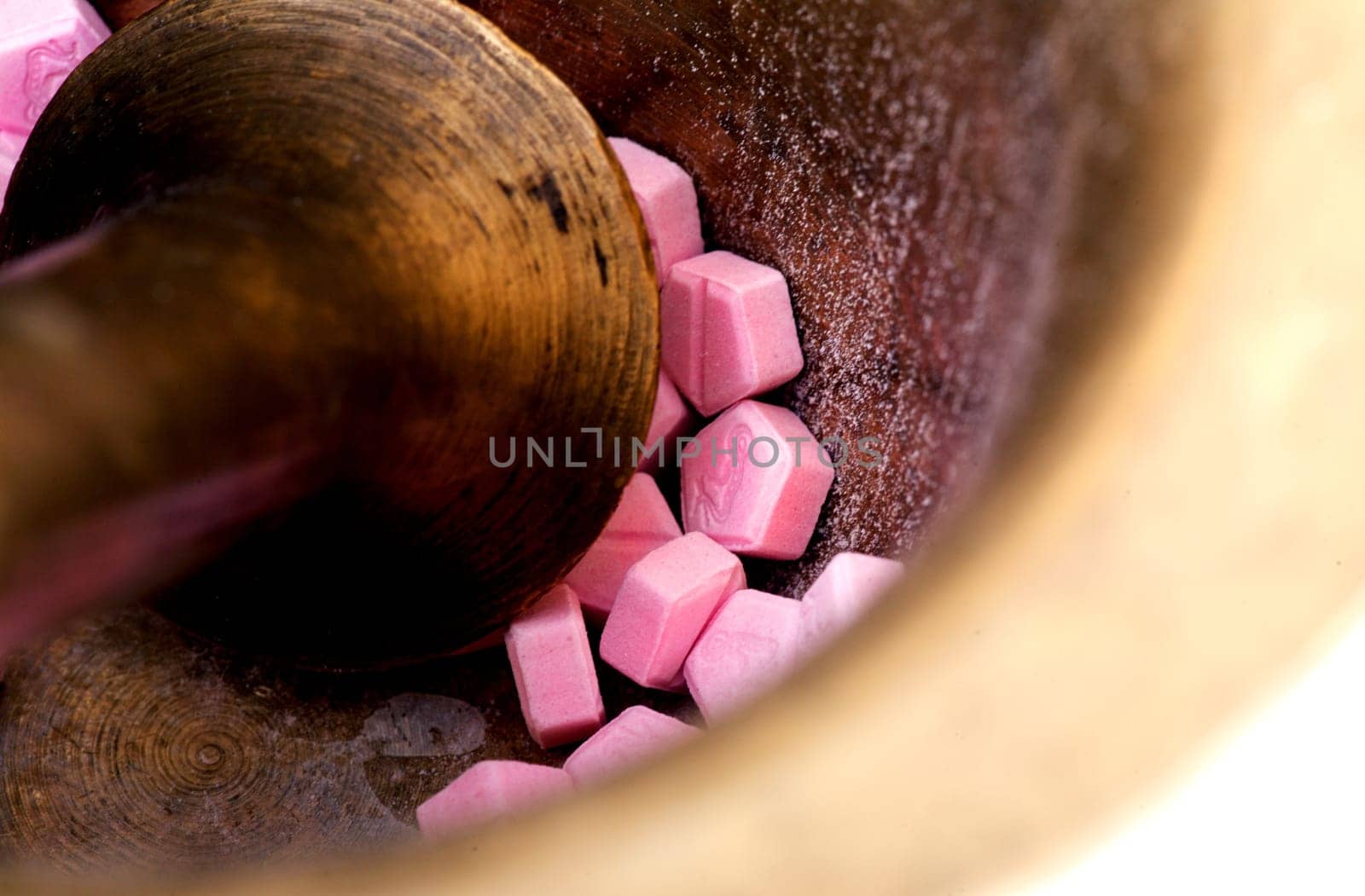 Pink tablets in a mortar