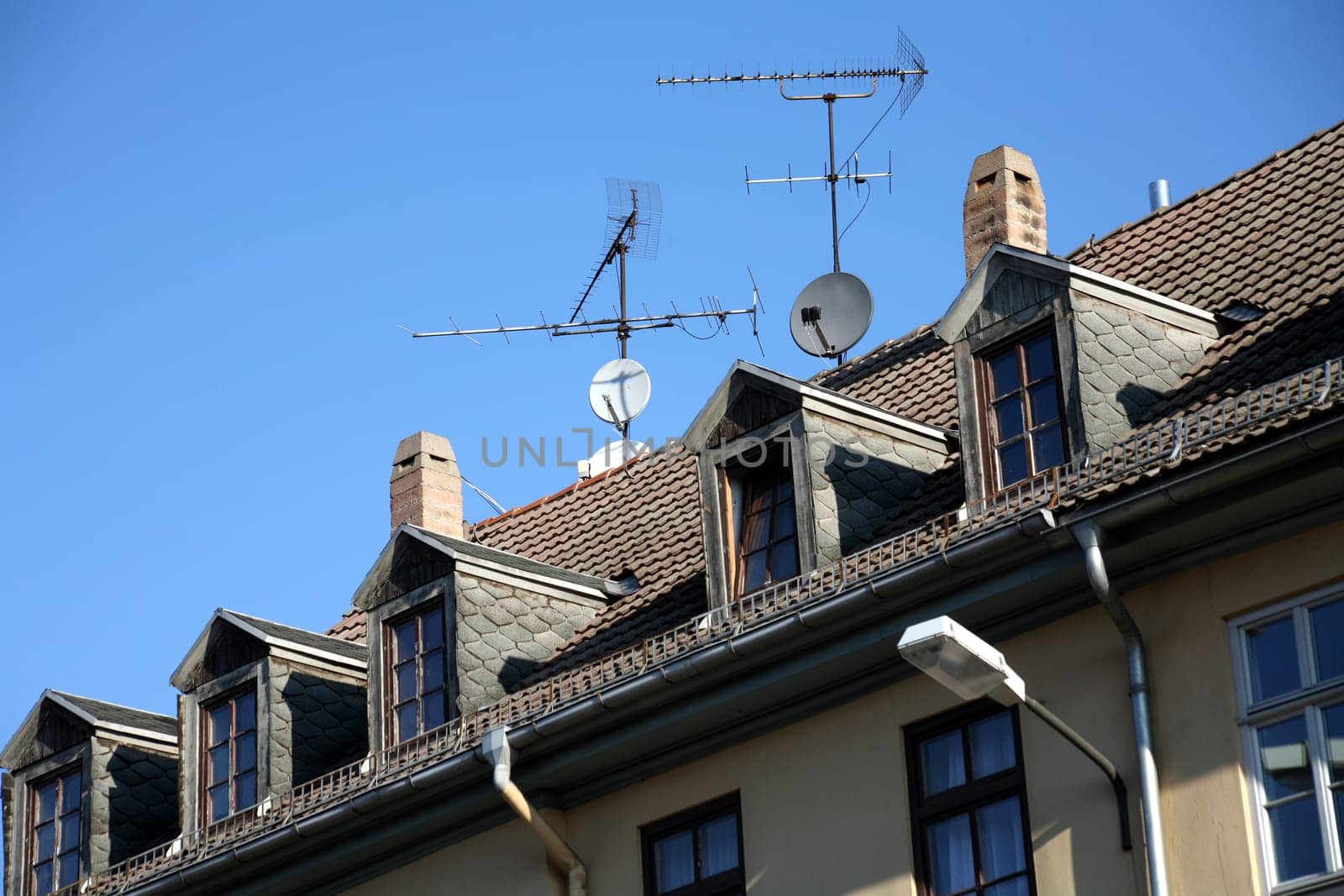 Antennas and satellite dishes on a residential building