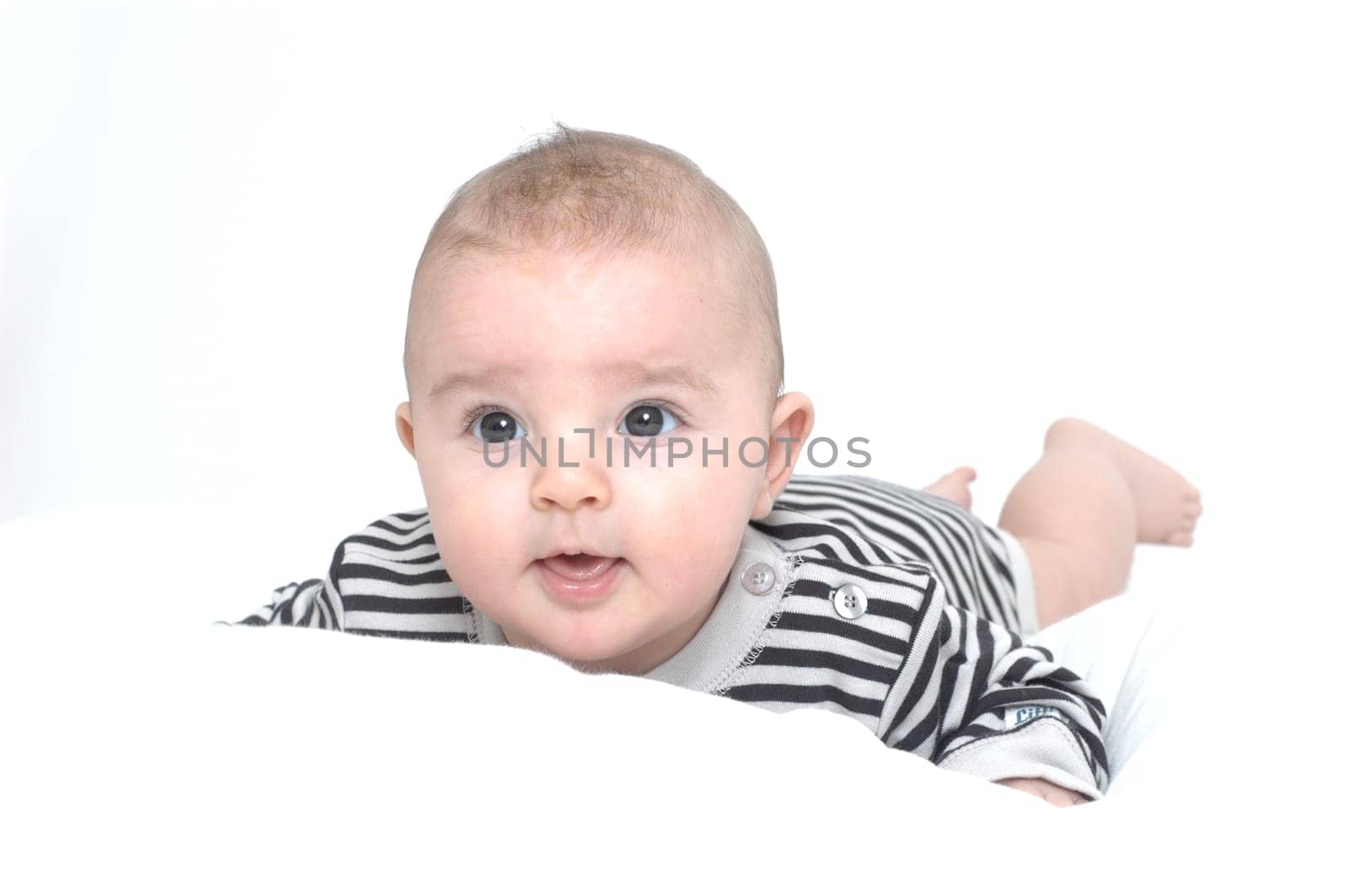 baby on white pillow