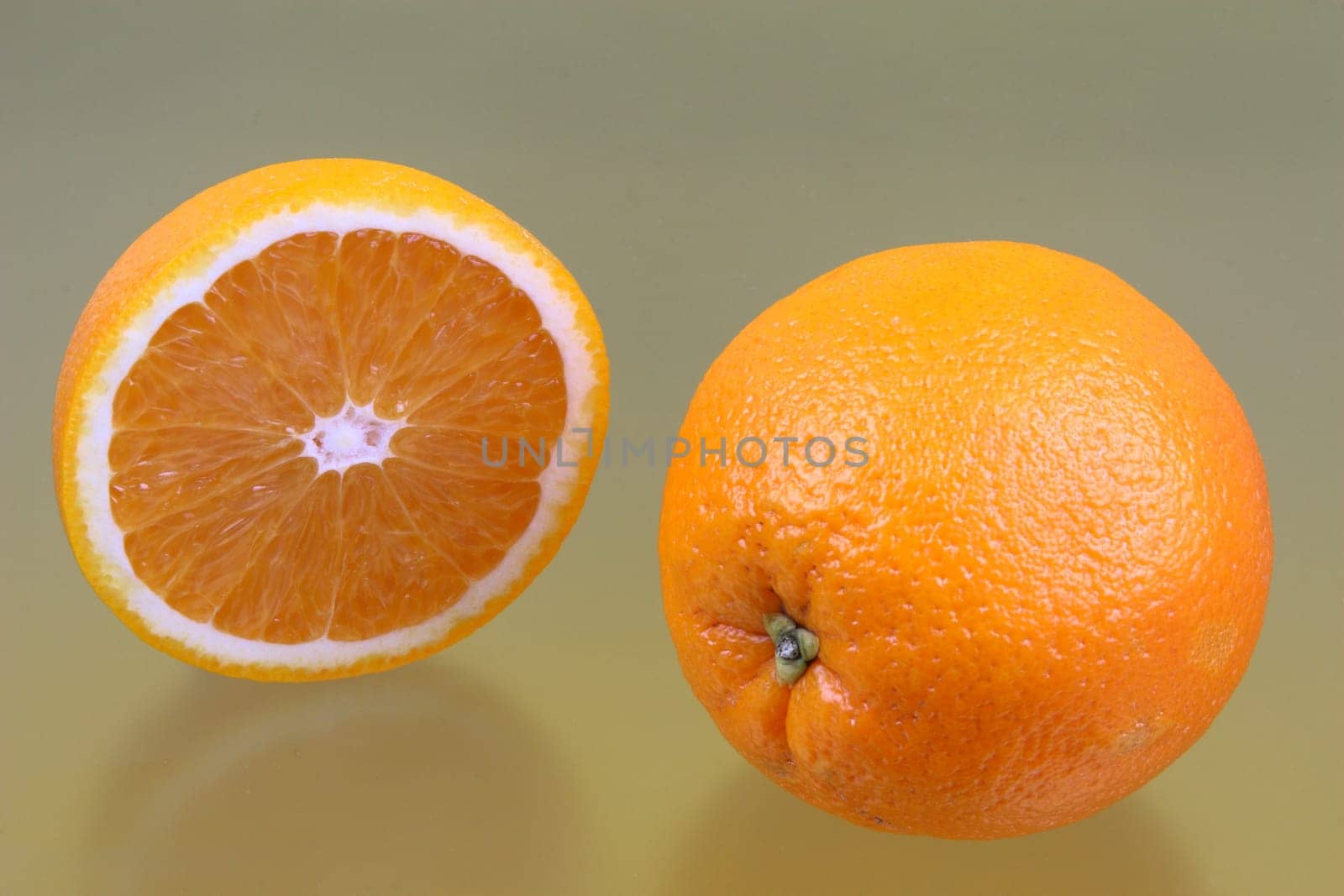 Half orange and whole fruit