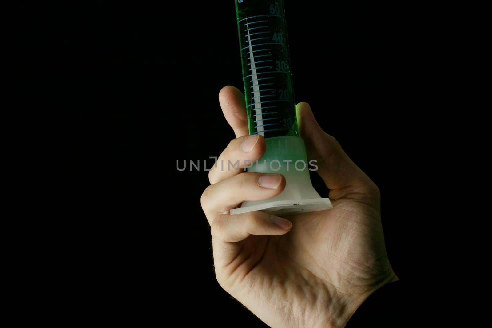Measuring cylinder in hand