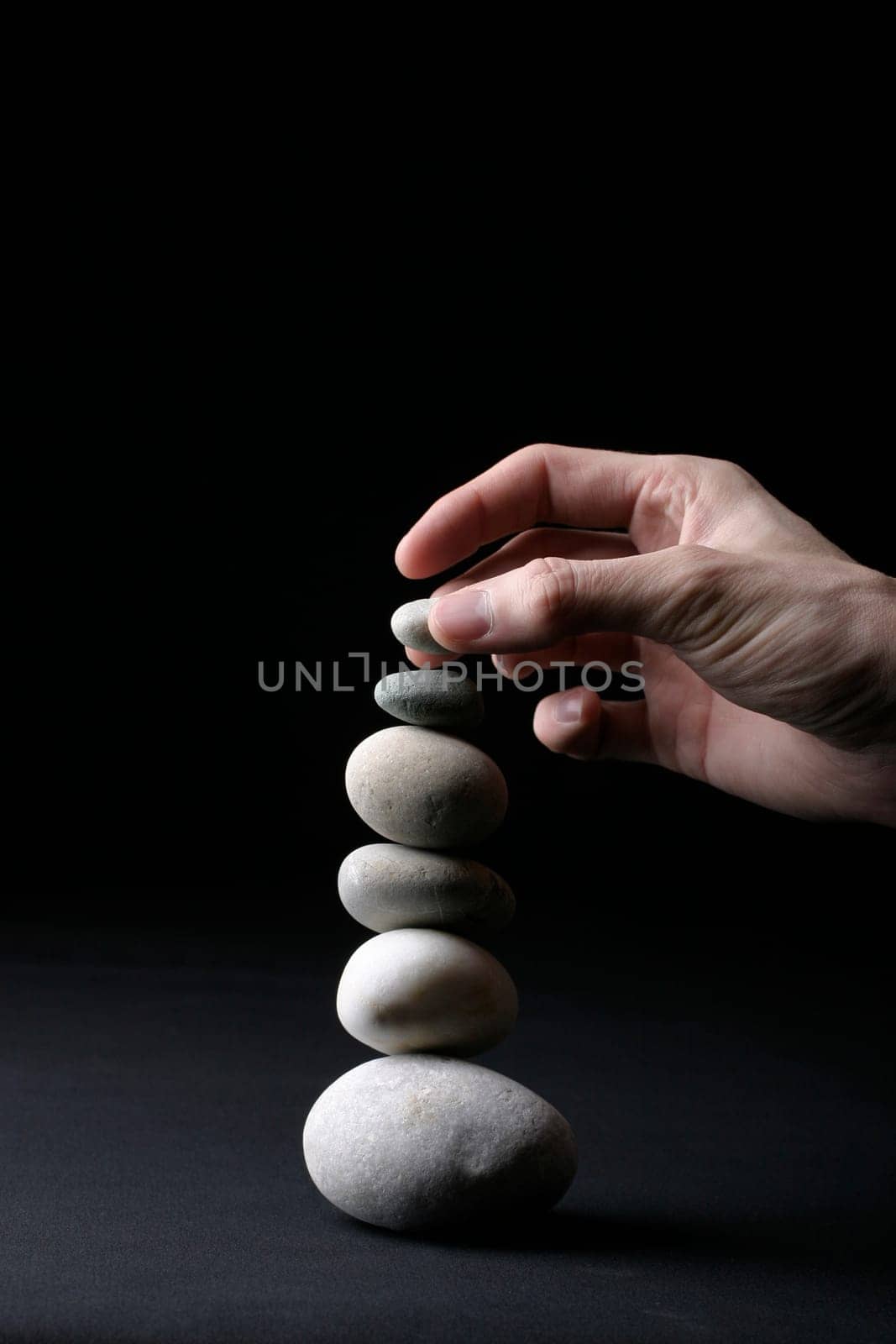 Stone pyramid and hand
