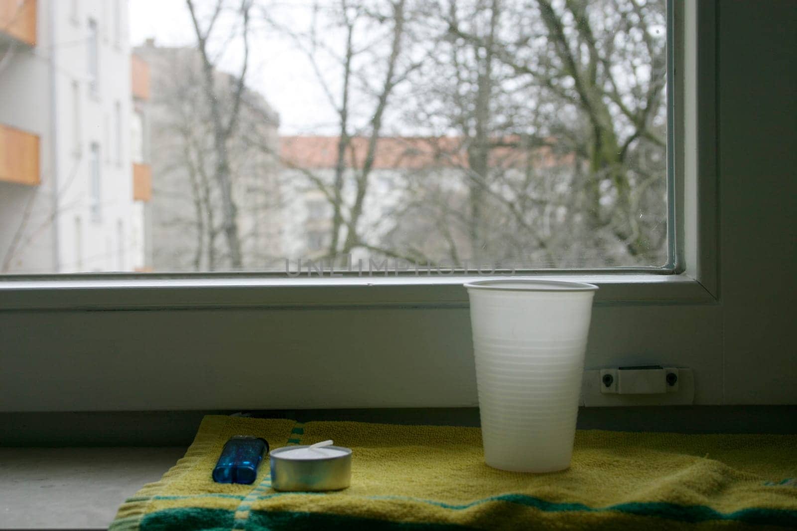 Window sill,mug,candle,lighter