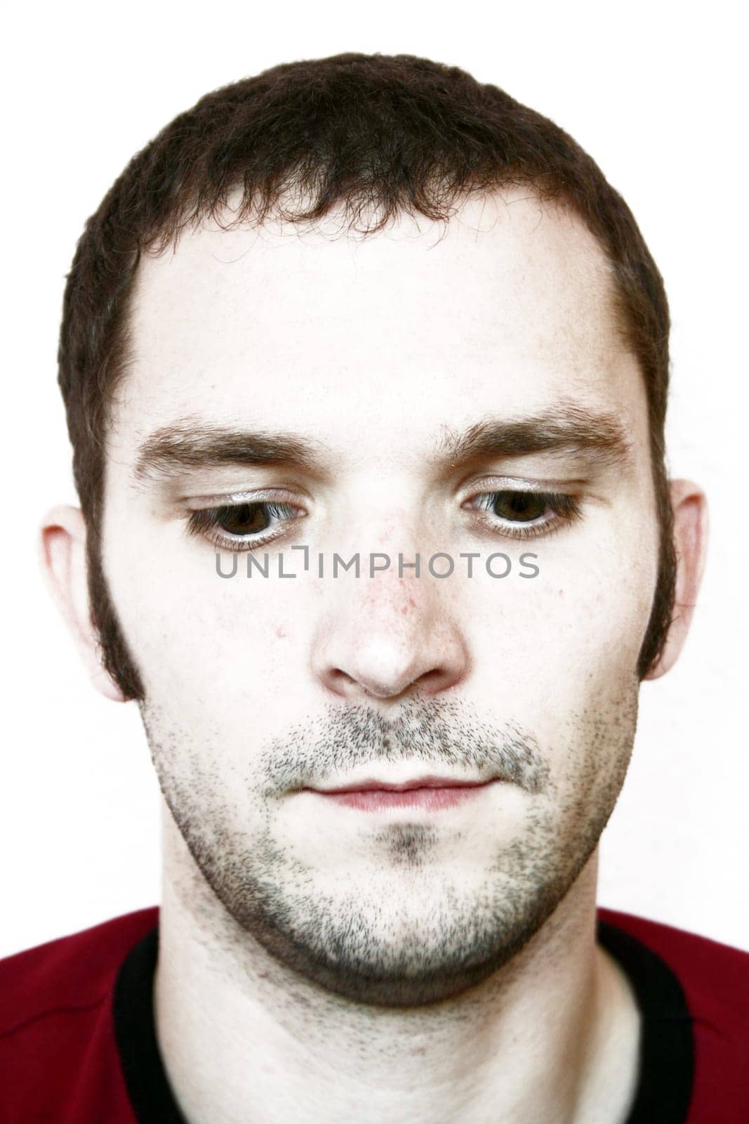 Man,unshaven,looking down