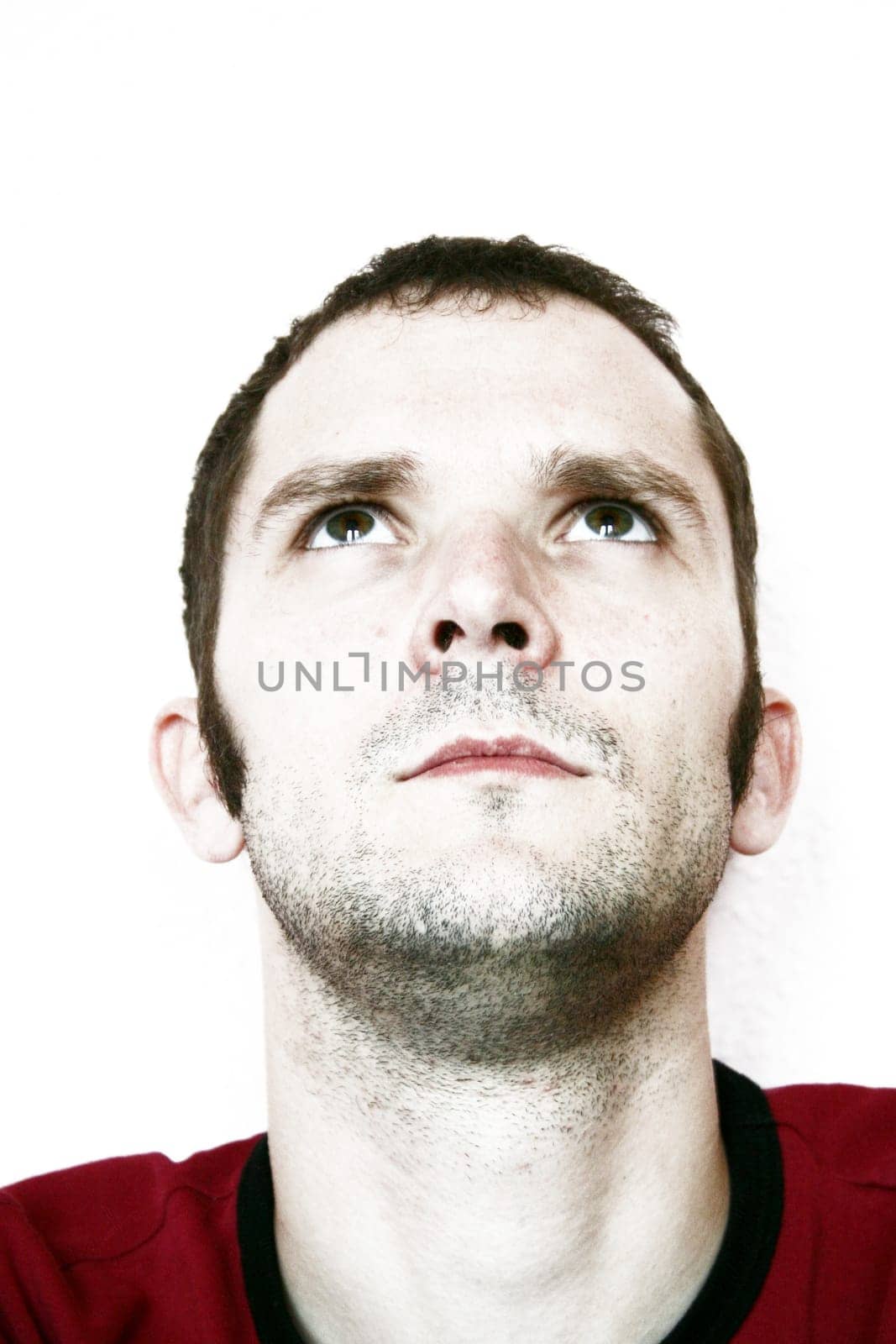 Man,unshaven,looking up